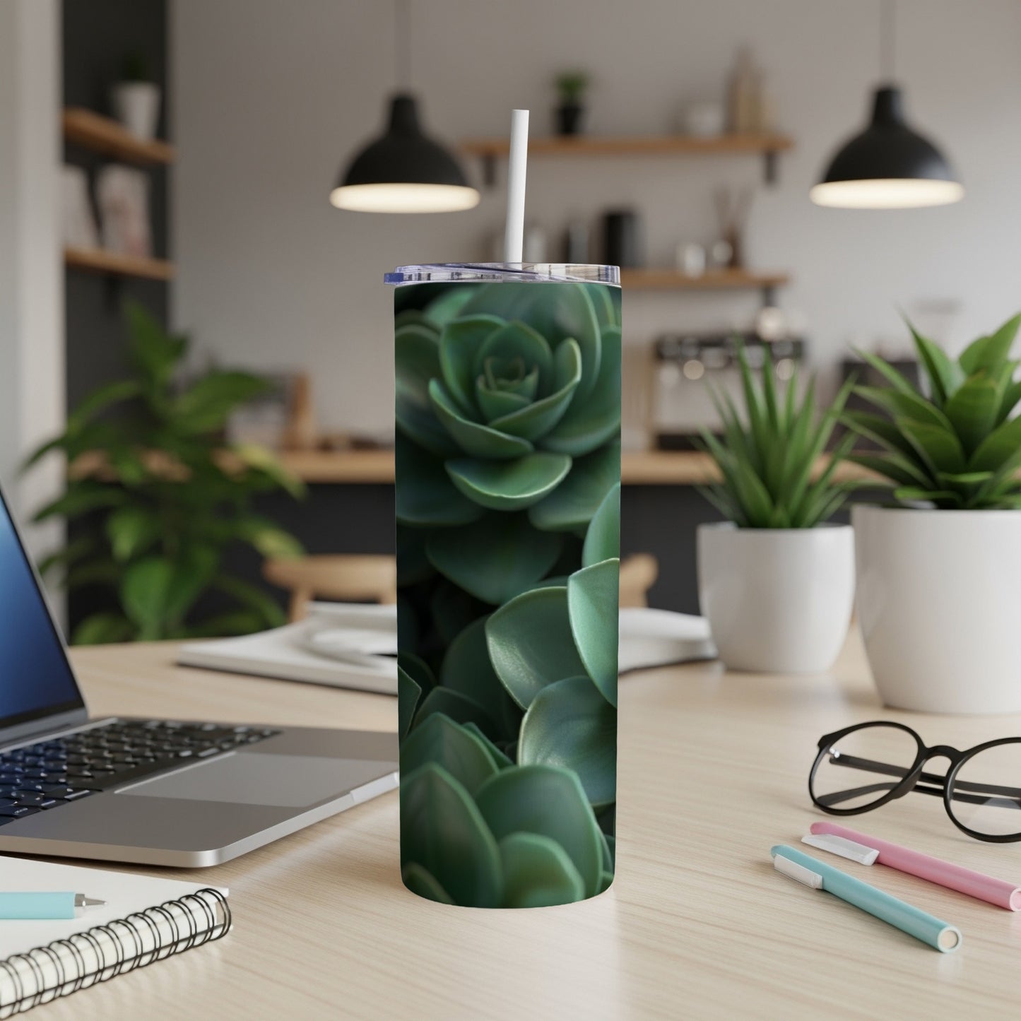 Green succulent plant pattern on a white tumbler with a straw.