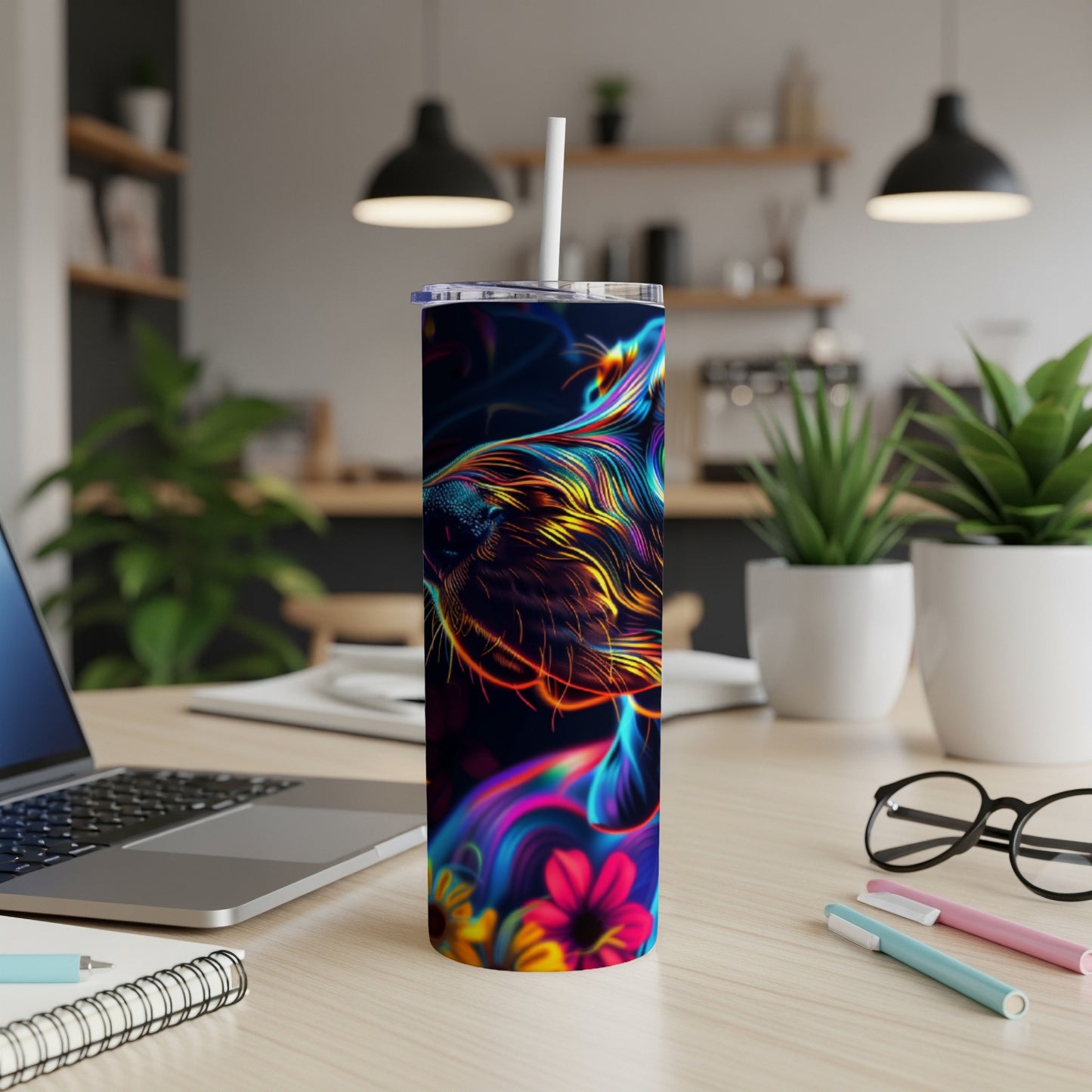 Colorful dog portrait on a dark tumbler with straw on a desk.