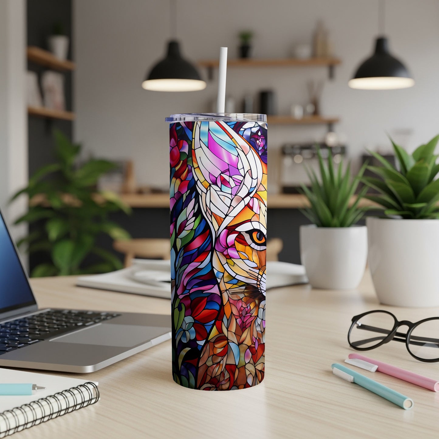 Tall tumbler with stained glass fox design and white straw.