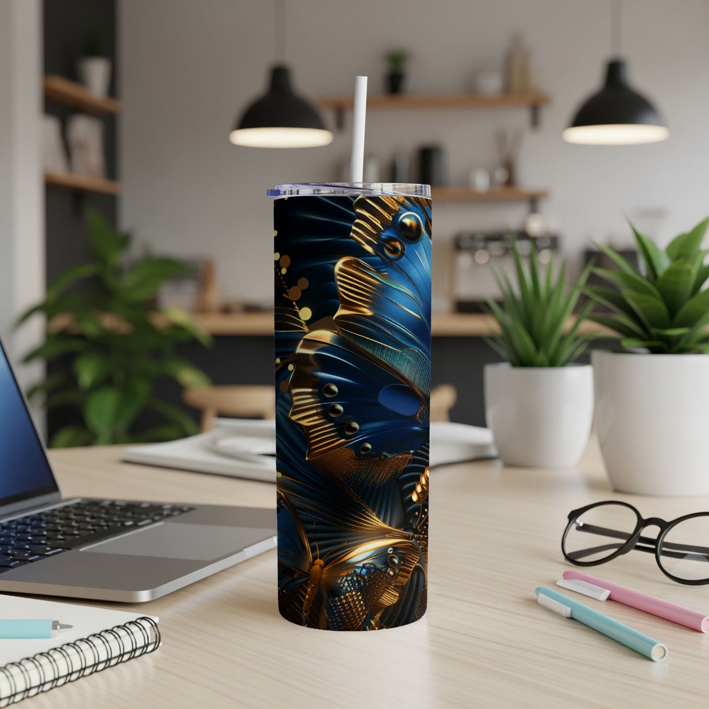 Blue and gold butterfly pattern on a tall tumbler with a straw.