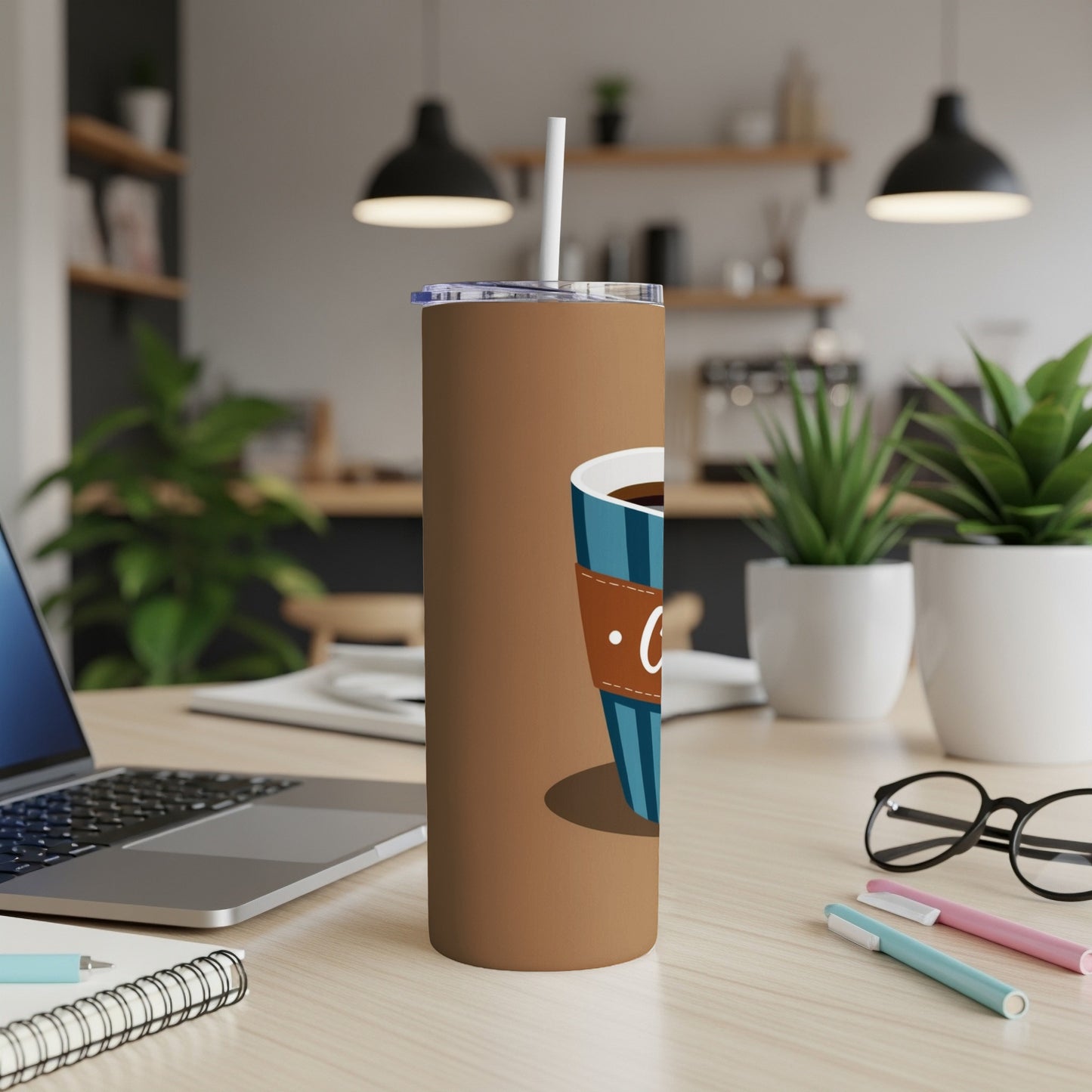 Brown tumbler with blue coffee cup graphic and white straw.