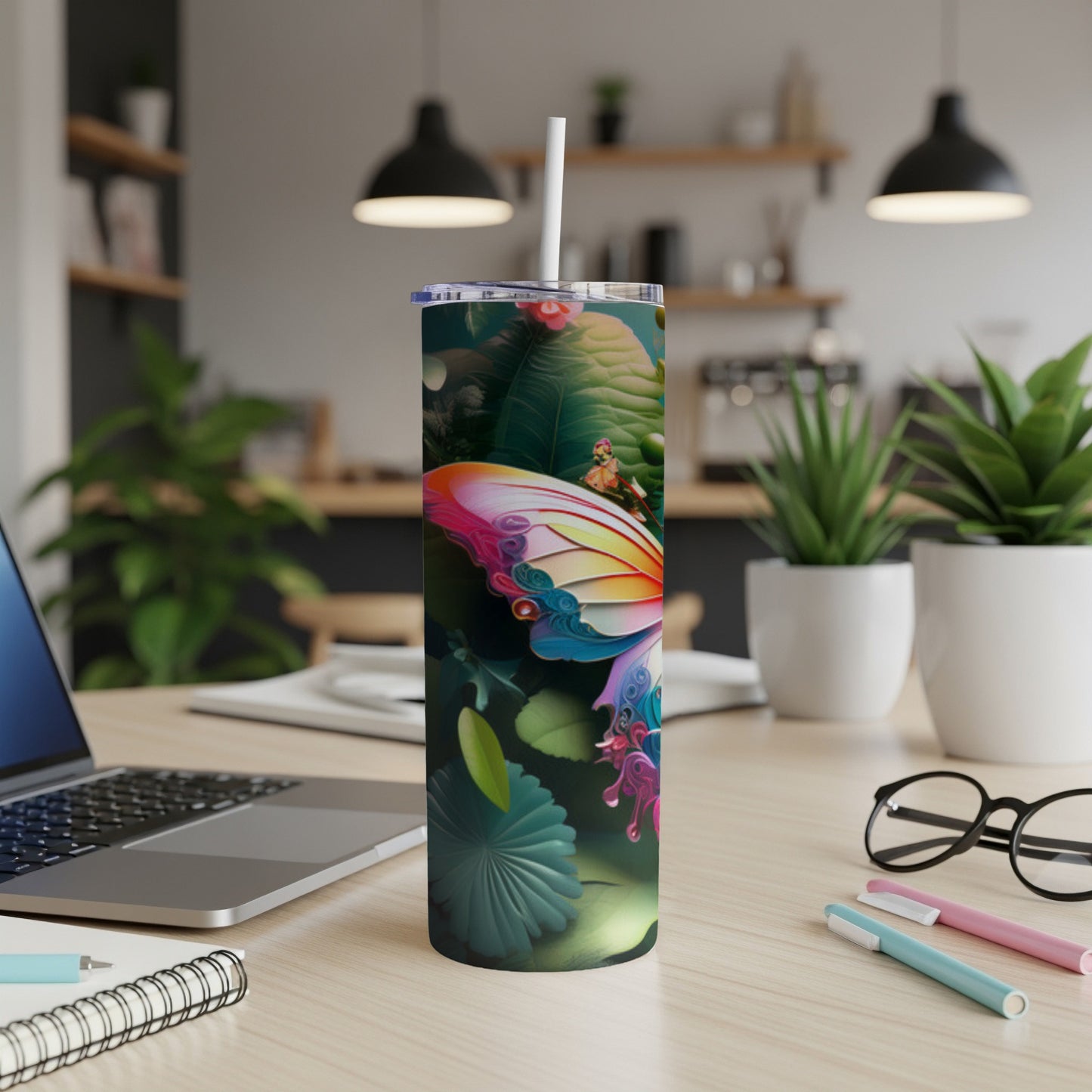 Butterfly design on a white tumbler with a straw, on a wooden desk.