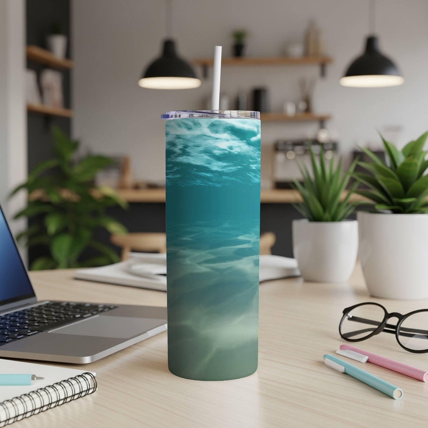 Blue and green underwater scene on a tumbler with a straw.