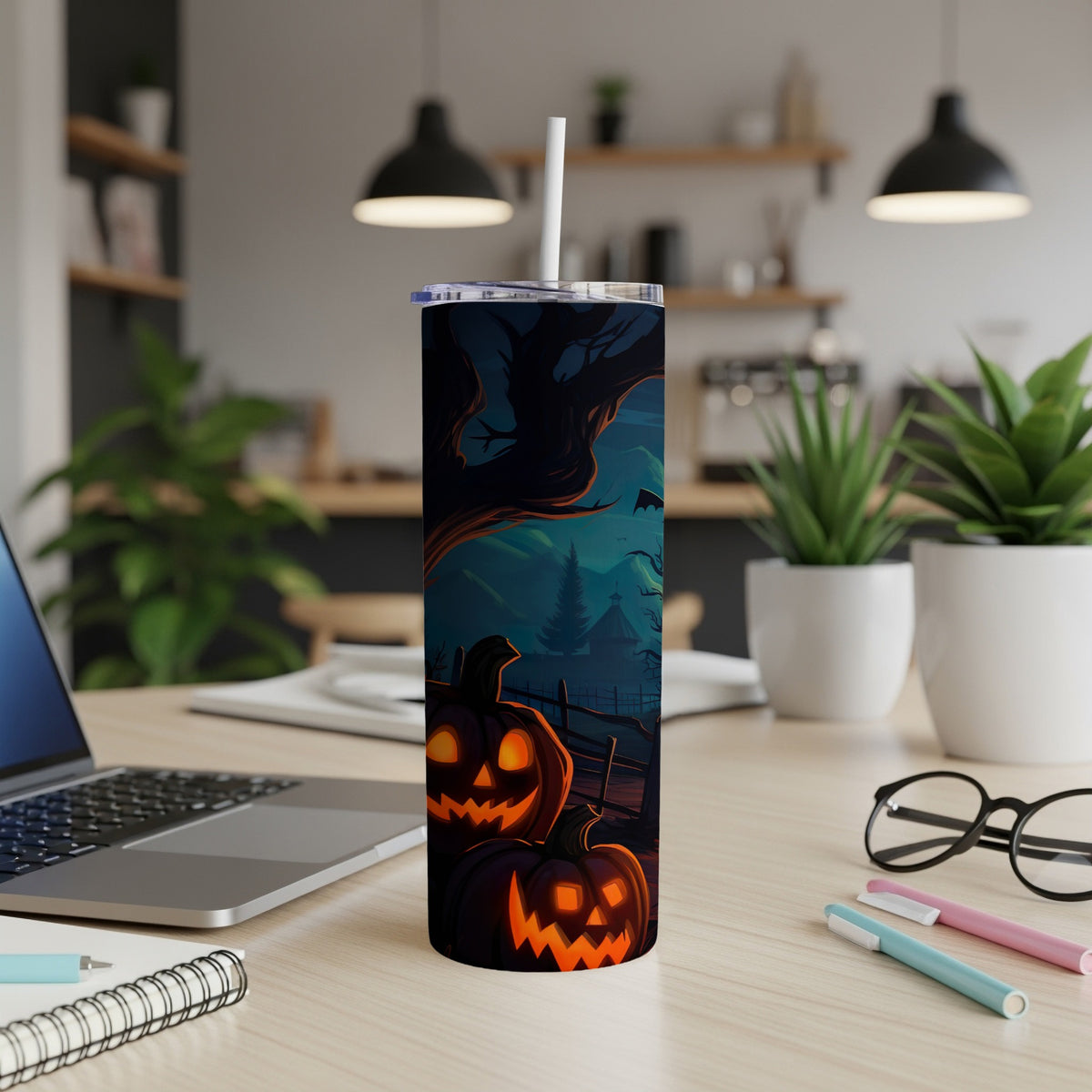 Tumbler with a spooky Halloween scene featuring carved pumpkins, a haunted tree, and bats.