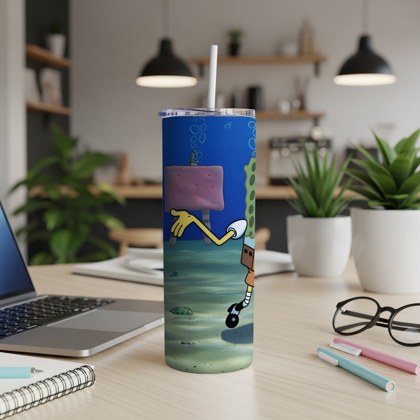 SpongeBob SquarePants character on a blue patterned skinny tumbler.