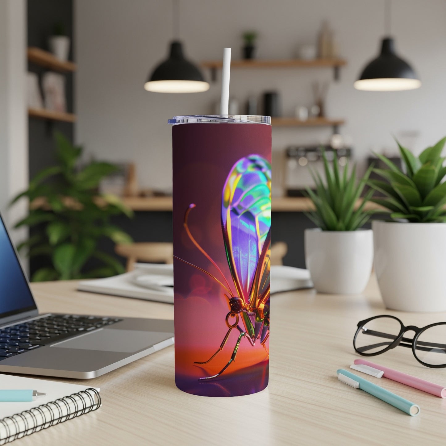 Iridescent butterfly design on a tall, slender tumbler with a straw.