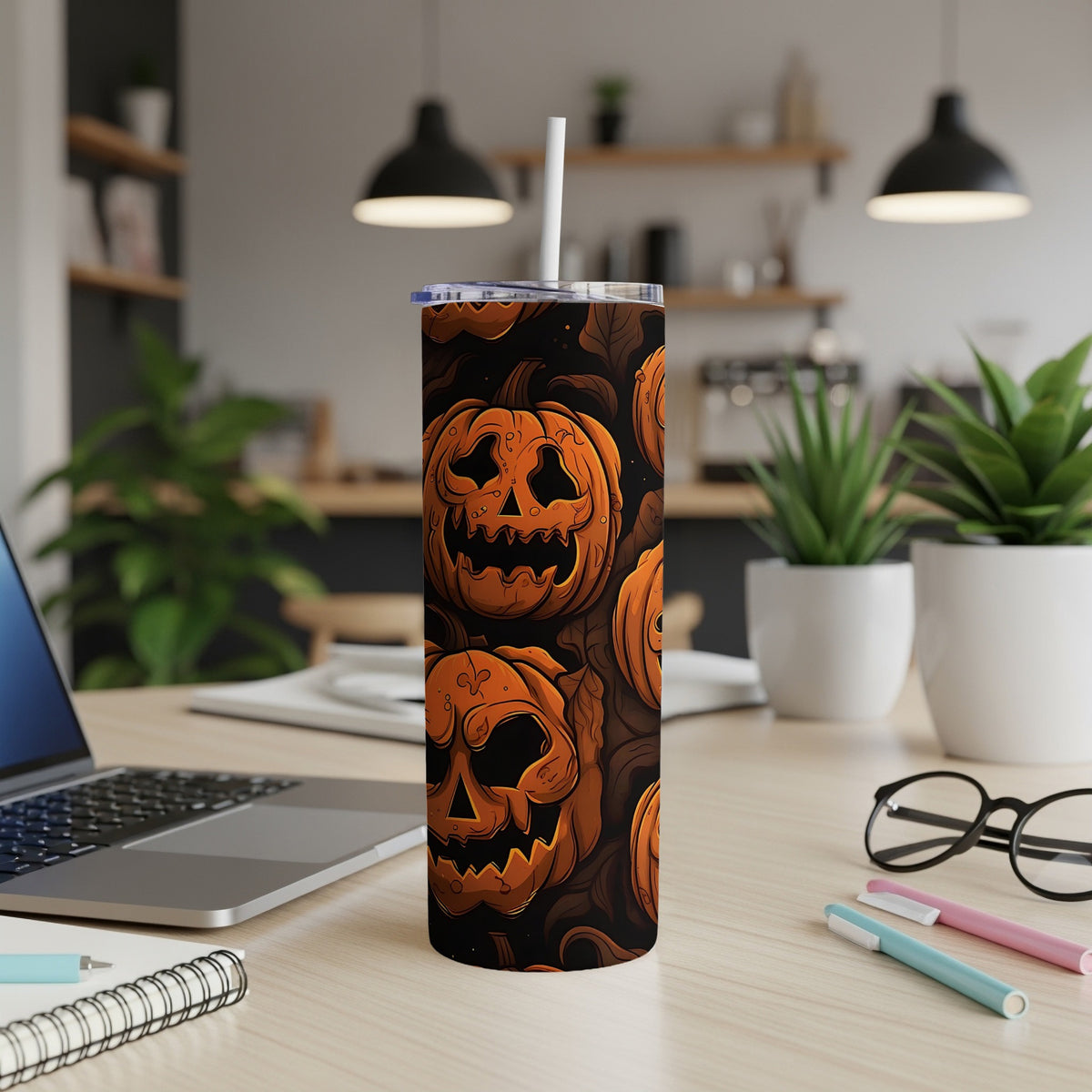 Tall tumbler with a Halloween pumpkin pattern and a white straw.