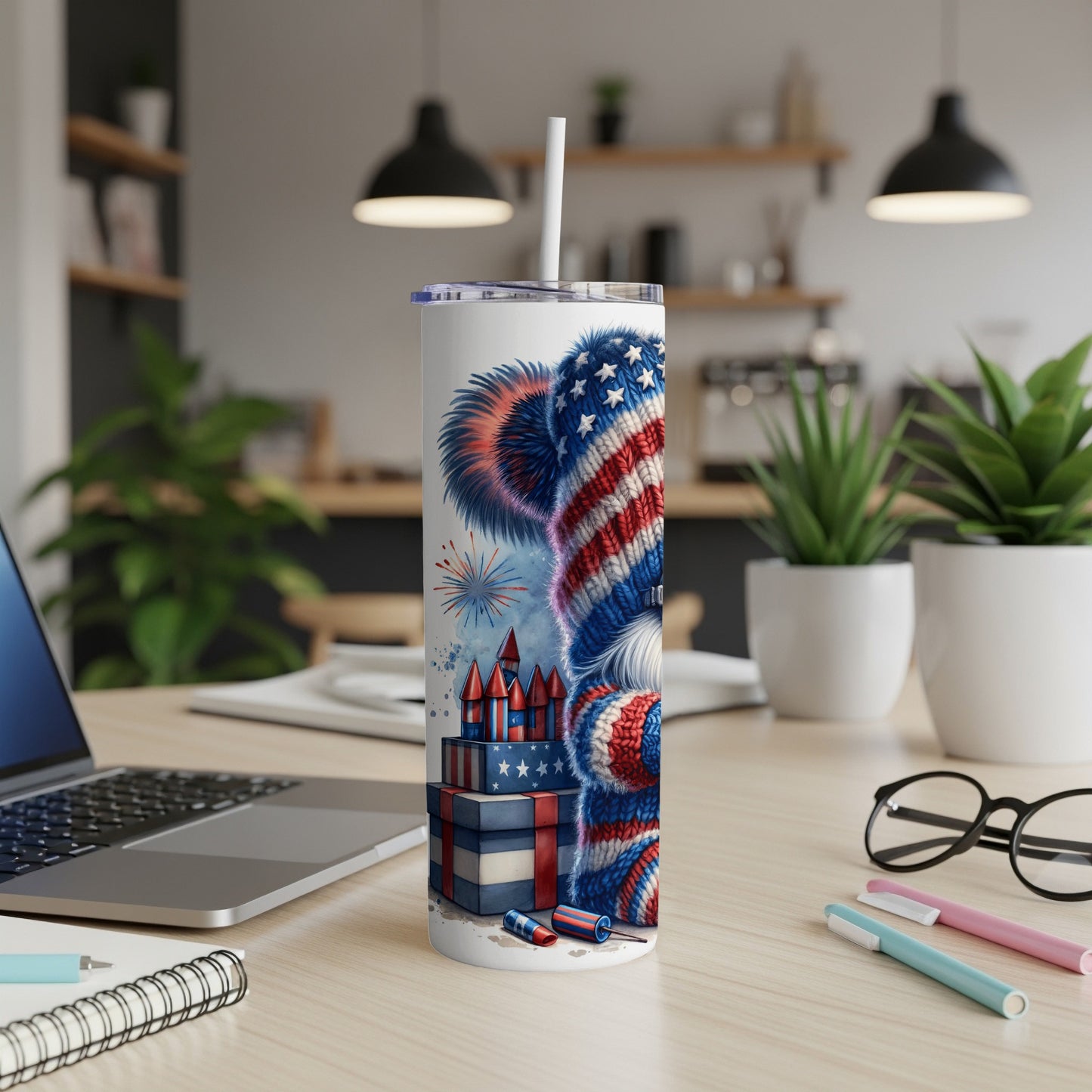 Patriotic dog tumbler with fireworks and gift boxes on a desk.