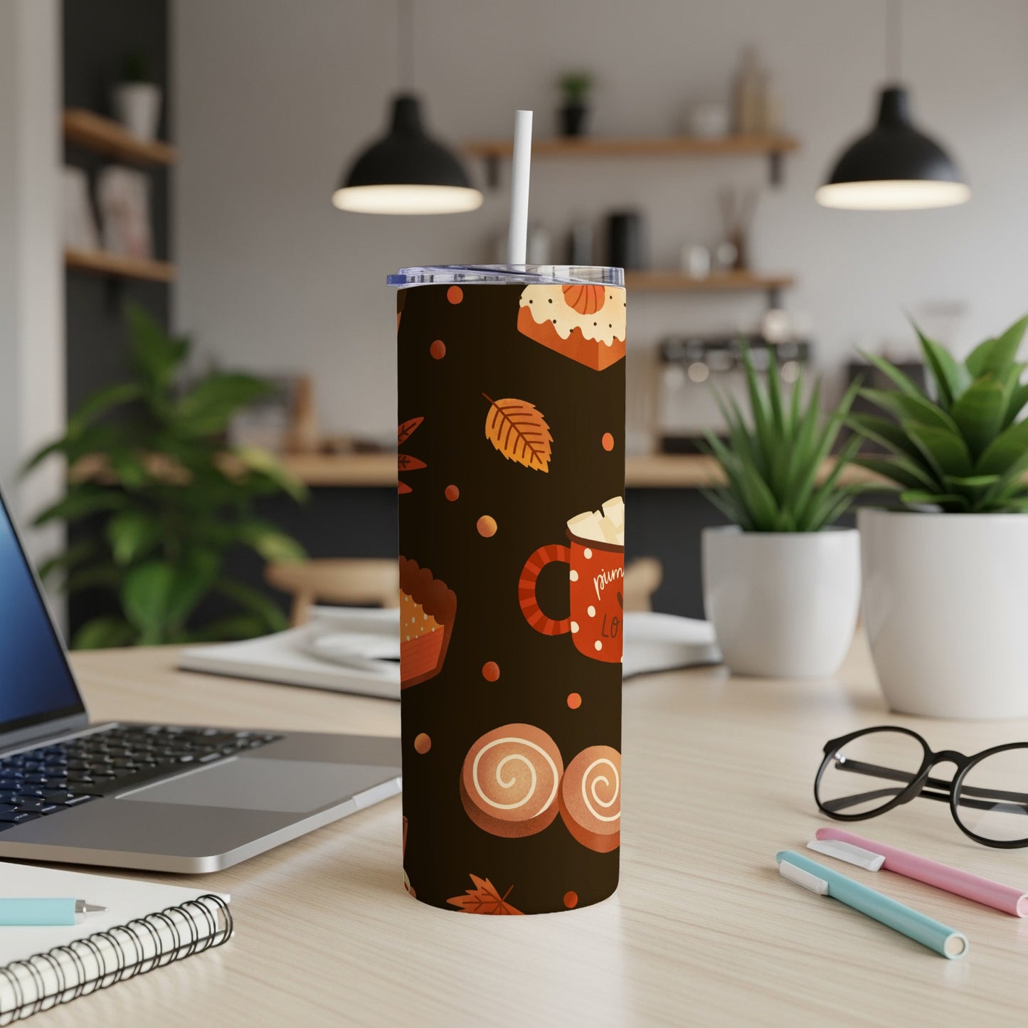 Tumbler with fall-themed pattern of pumpkins, cinnamon rolls, and leaves.