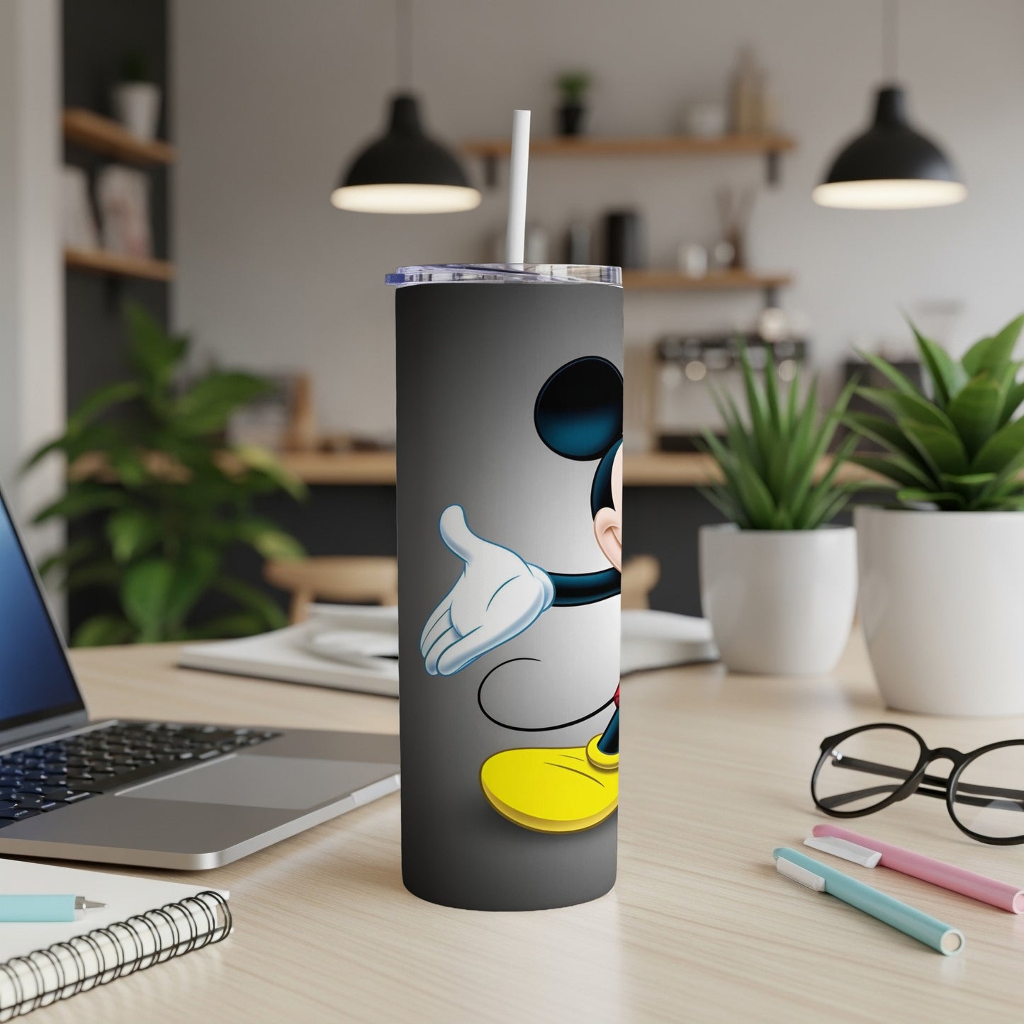 Mickey Mouse character on a black tumbler with a white straw.