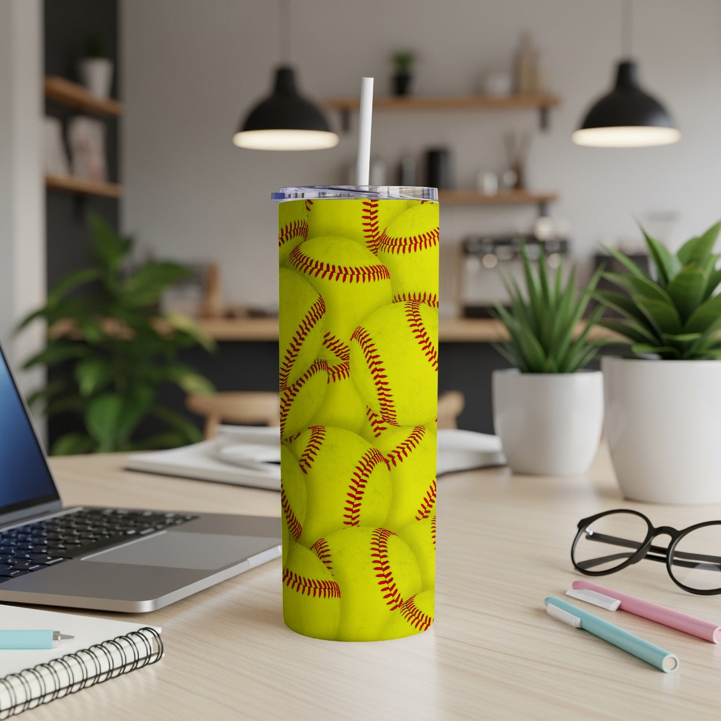 Yellow softball pattern on a white tumbler with a straw.