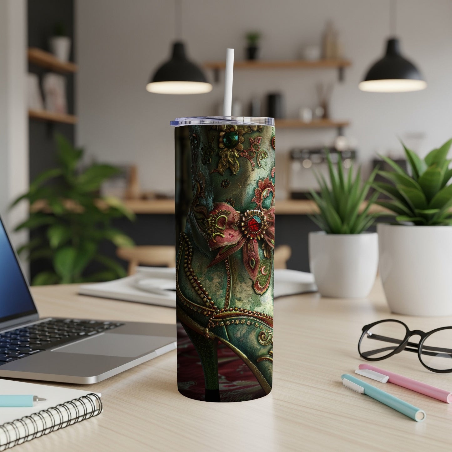 Decorative green and gold tumbler with intricate floral and jeweled embellishments.