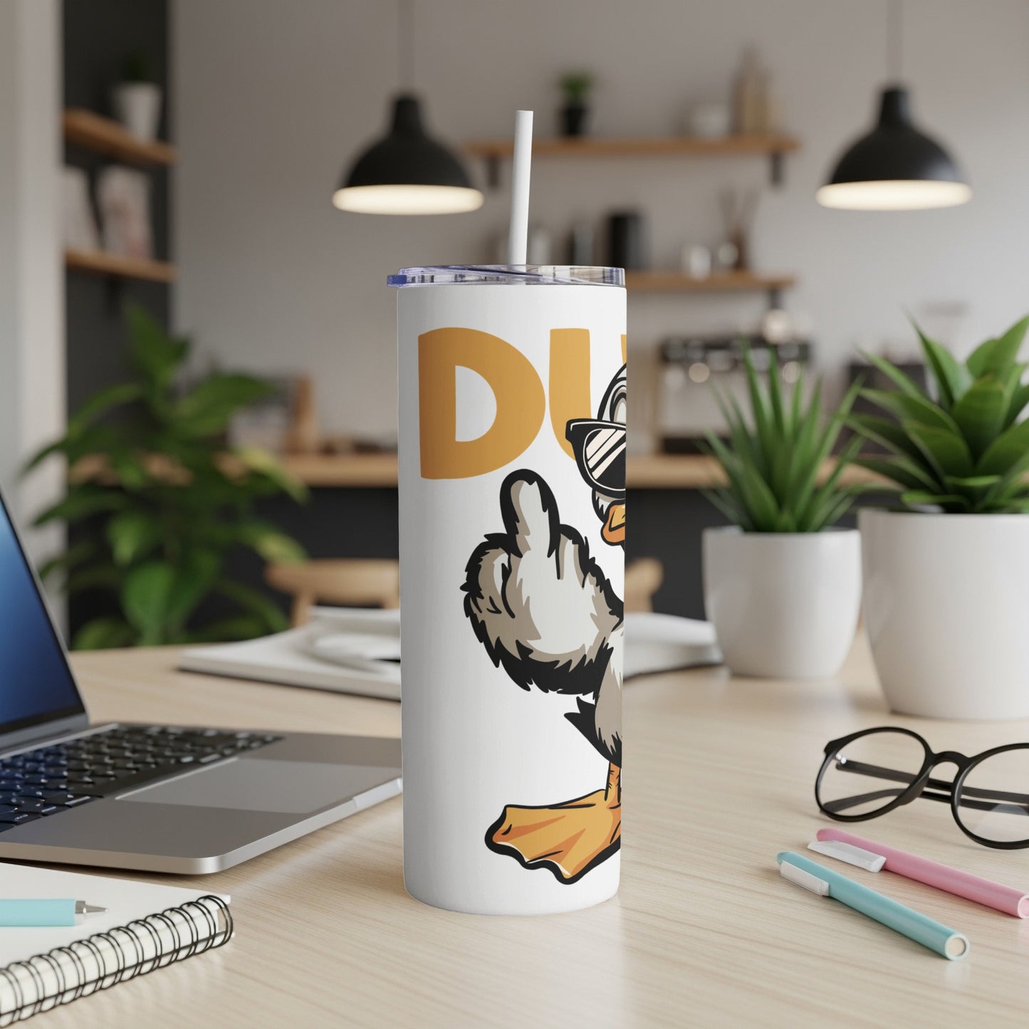White tumbler with cartoon duck wearing sunglasses giving a thumbs up.