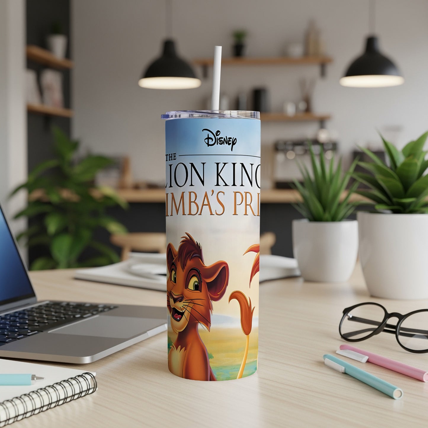 The Lion King Simba's Pride tumbler with laptop and office supplies.