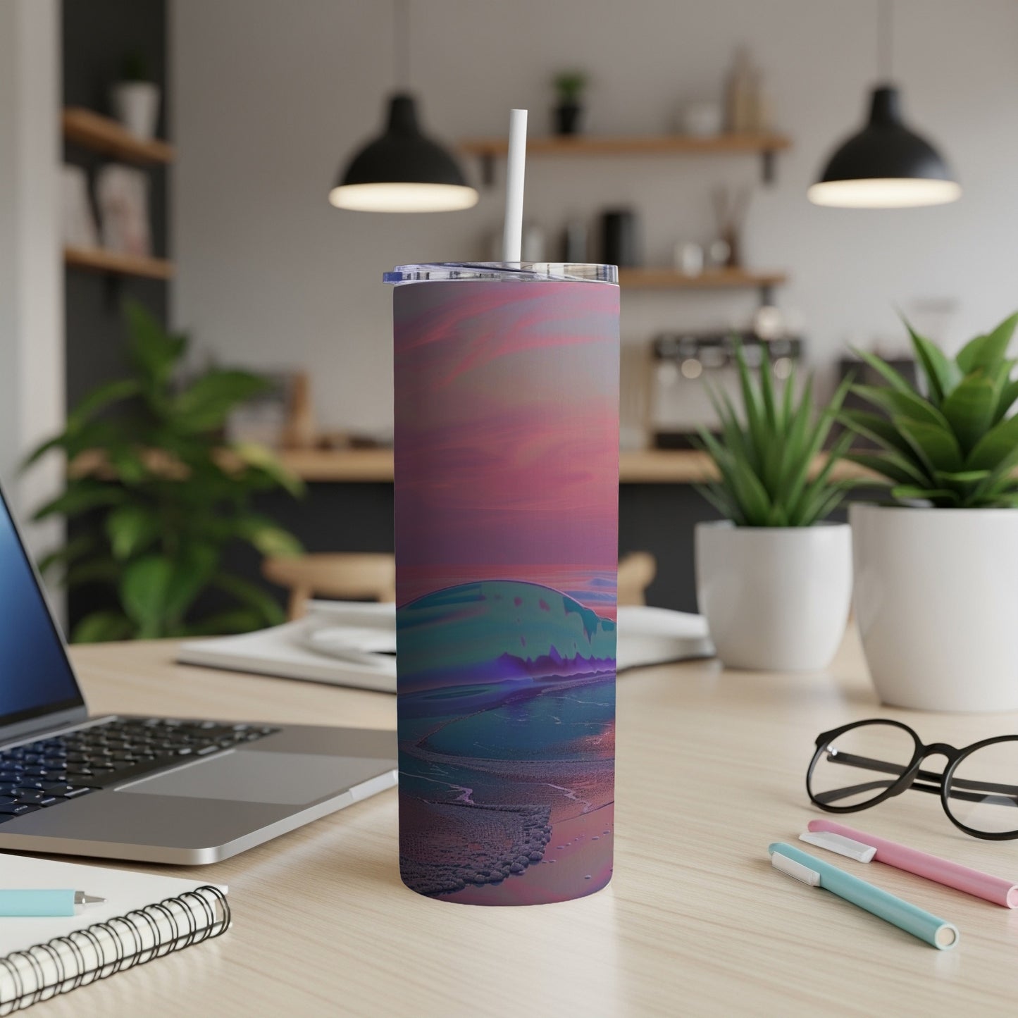 Gradient sunset over ocean waves on a travel tumbler with straw.