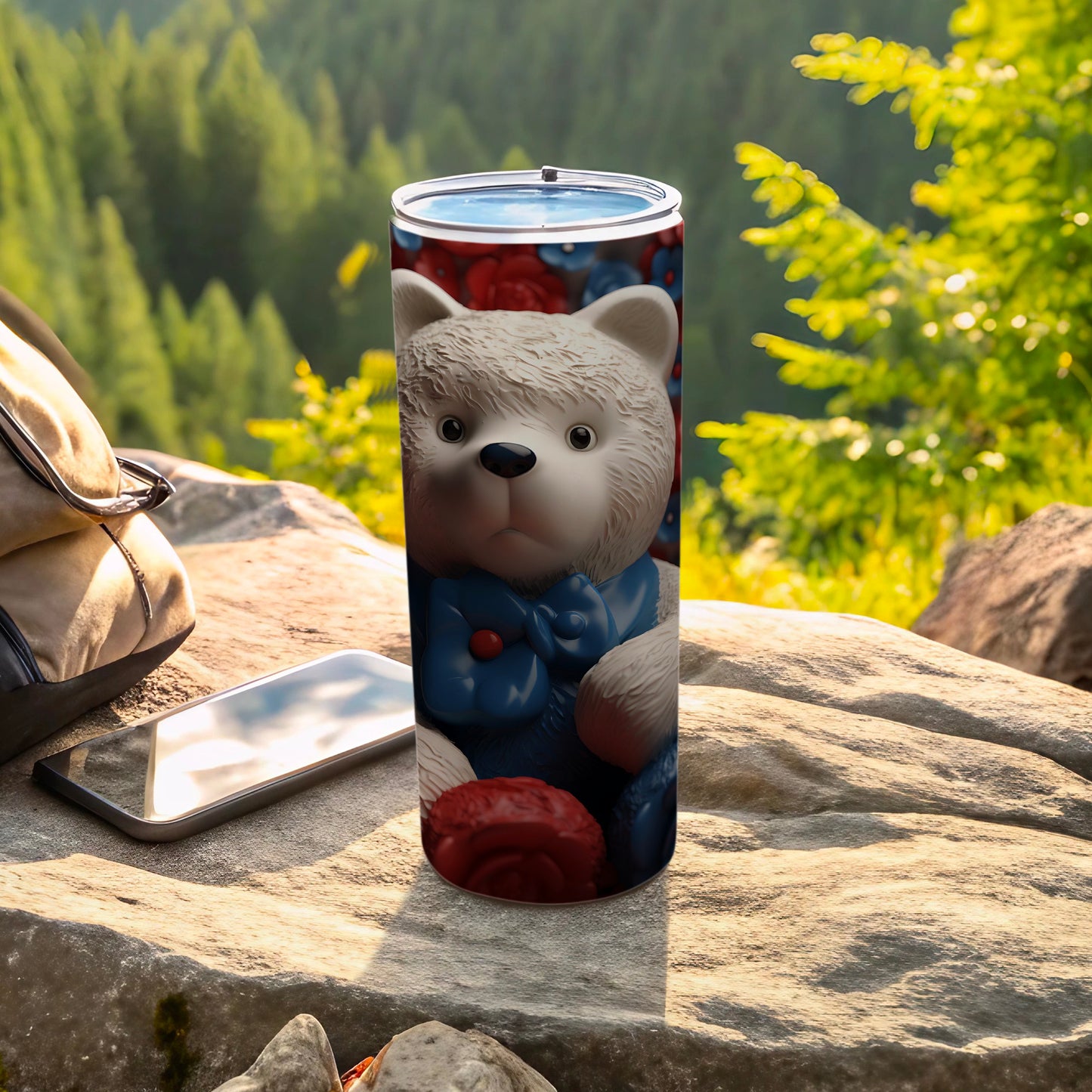 White teddy bear with blue bow on a travel tumbler.