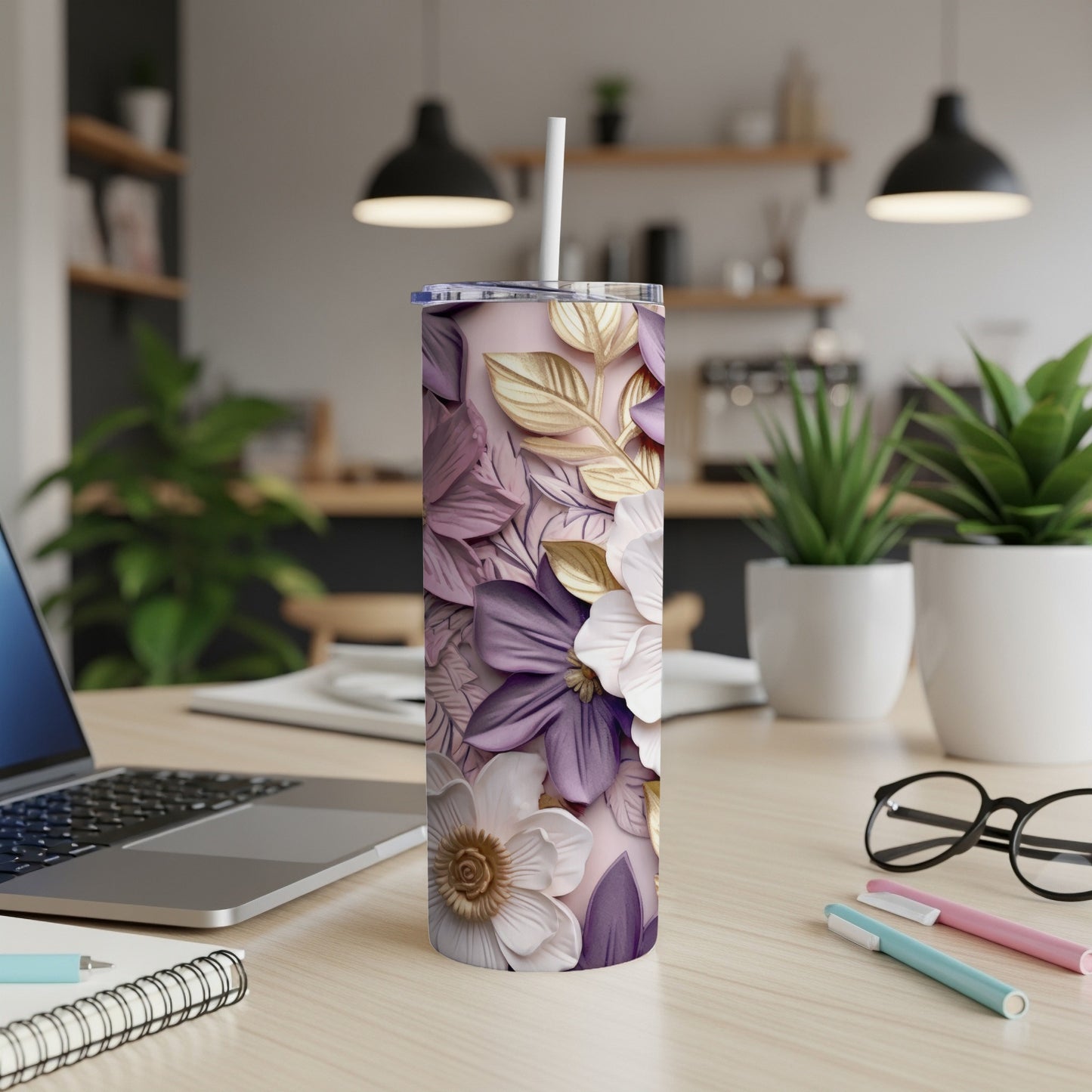Lavender tumbler with raised floral design and white straw on desk.