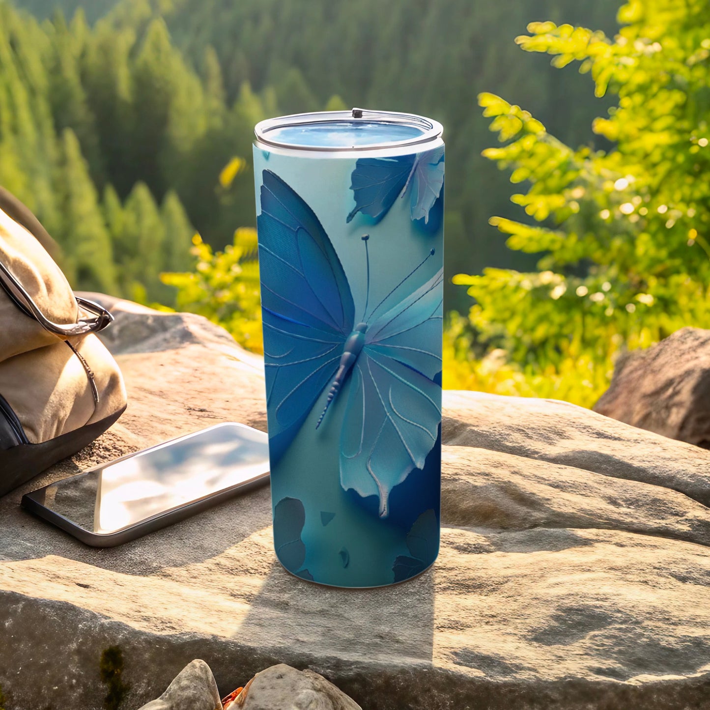 Blue butterfly on a teal background, printed on a stainless steel tumbler.