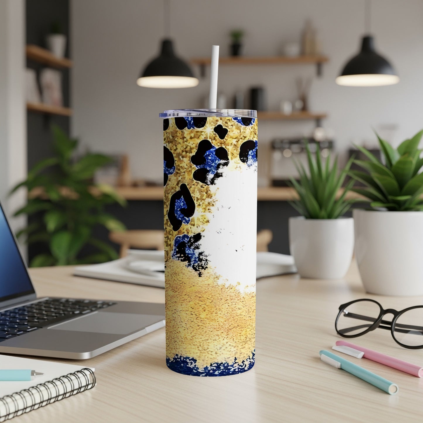 White skinny tumbler with gold glitter and blue leopard print.