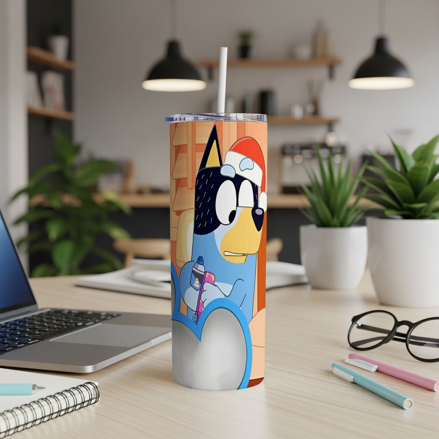 Bluey character in a Santa hat holding a purple marker, on a skinny tumbler.