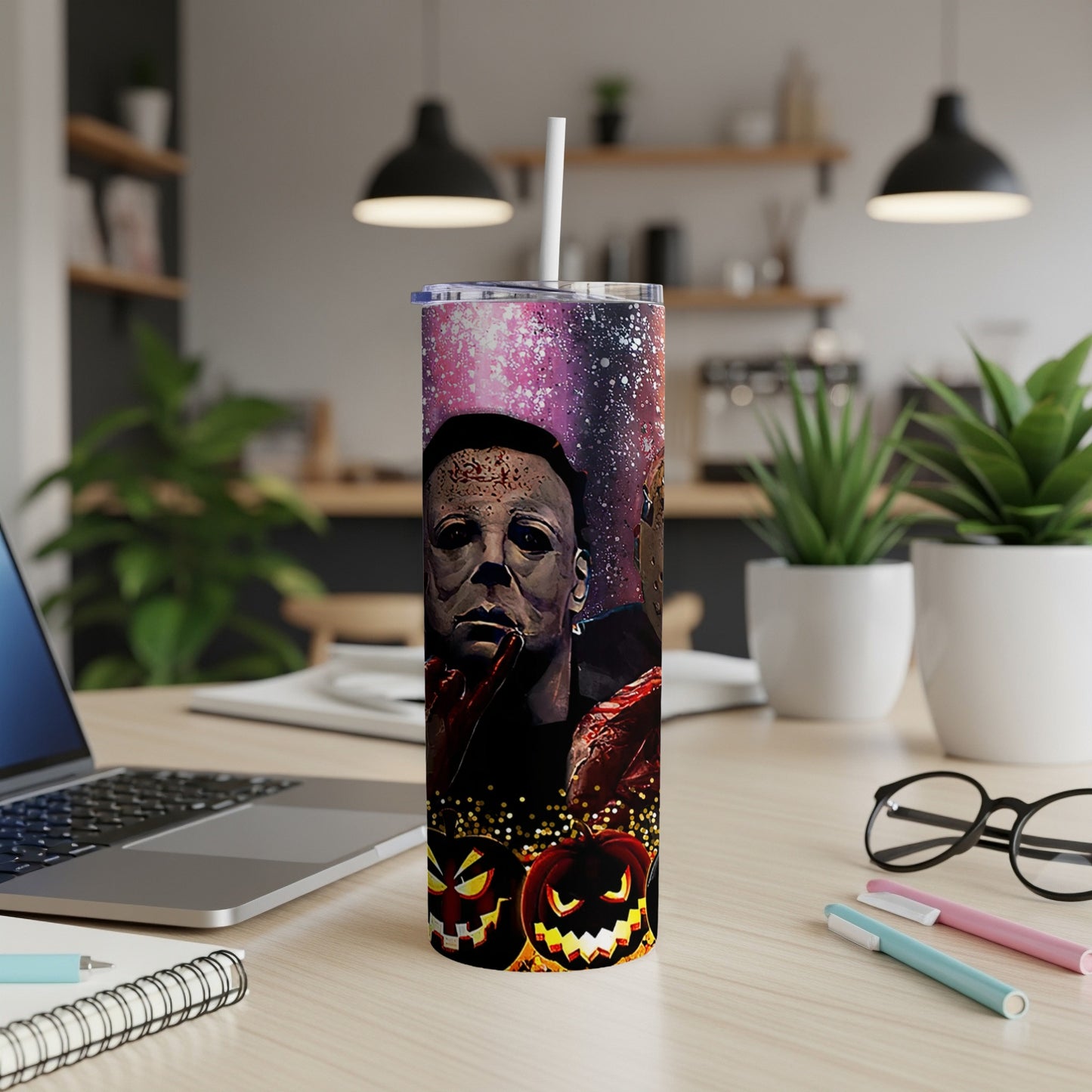 Michael Myers with pumpkins on a galaxy-themed tumbler cup.