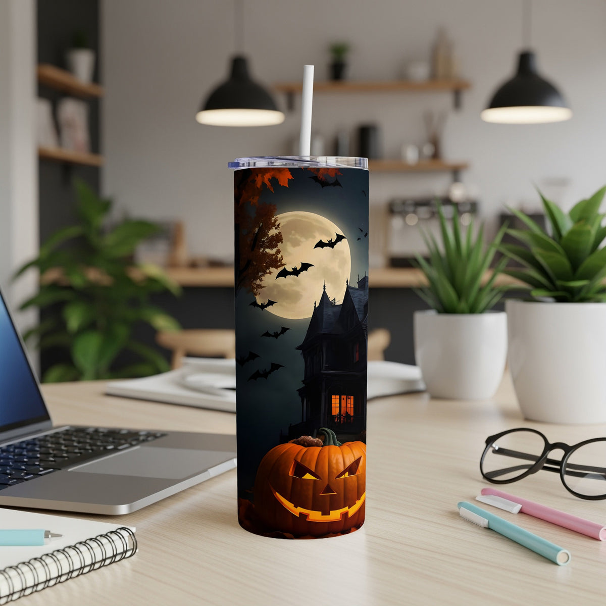 Halloween tumbler with jack-o'-lantern, haunted house, bats, and moon on dark background.