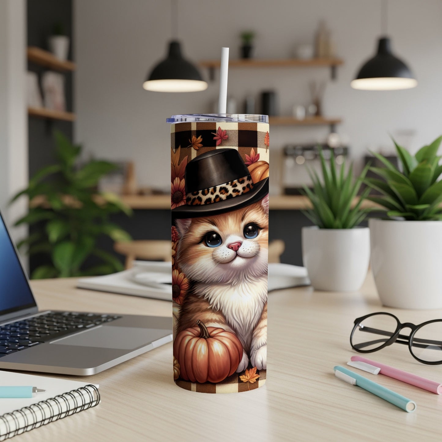Cute cartoon cat wearing a fall hat, sitting next to pumpkins on a tumbler.