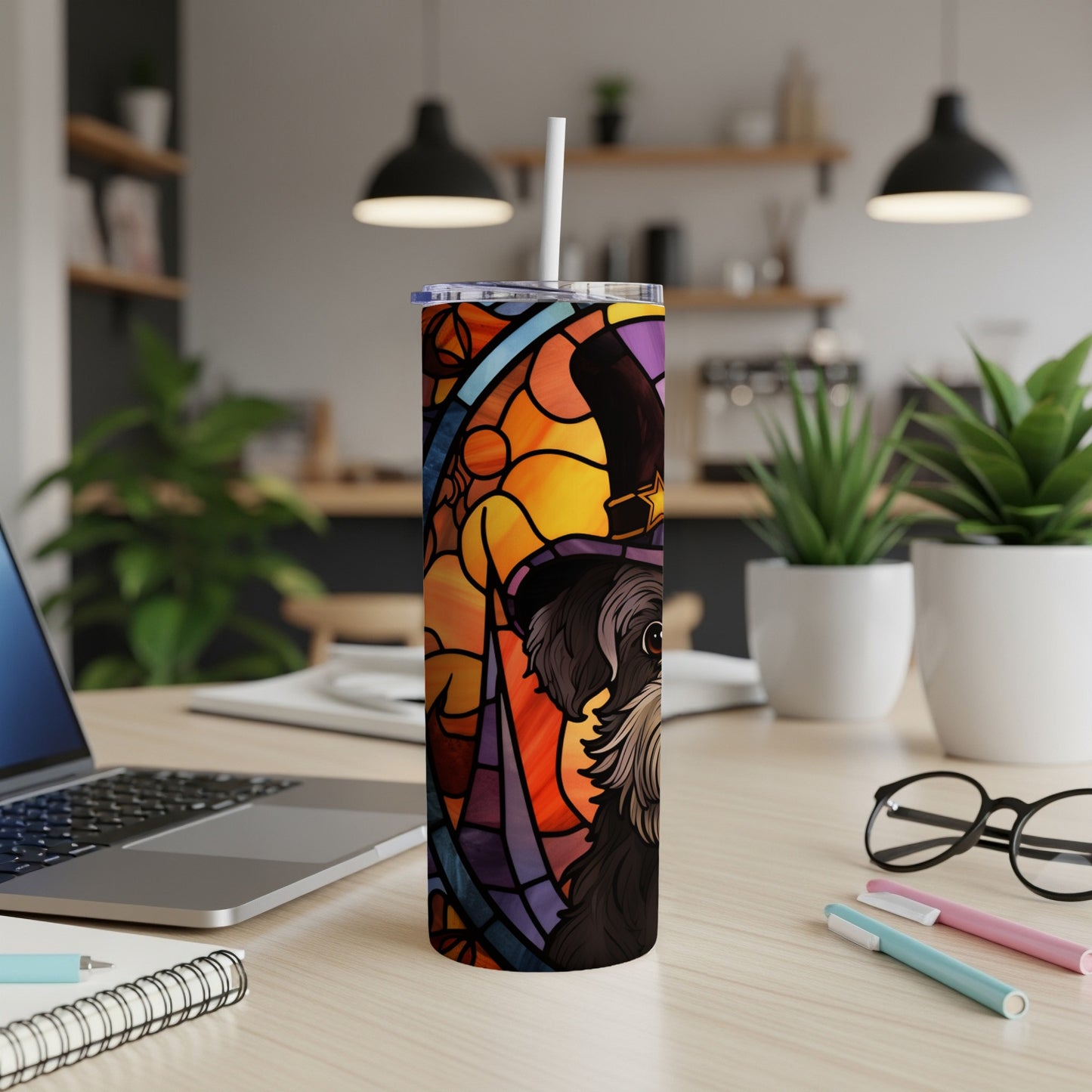 Black dog wearing a witch hat on a stained-glass style tumbler.