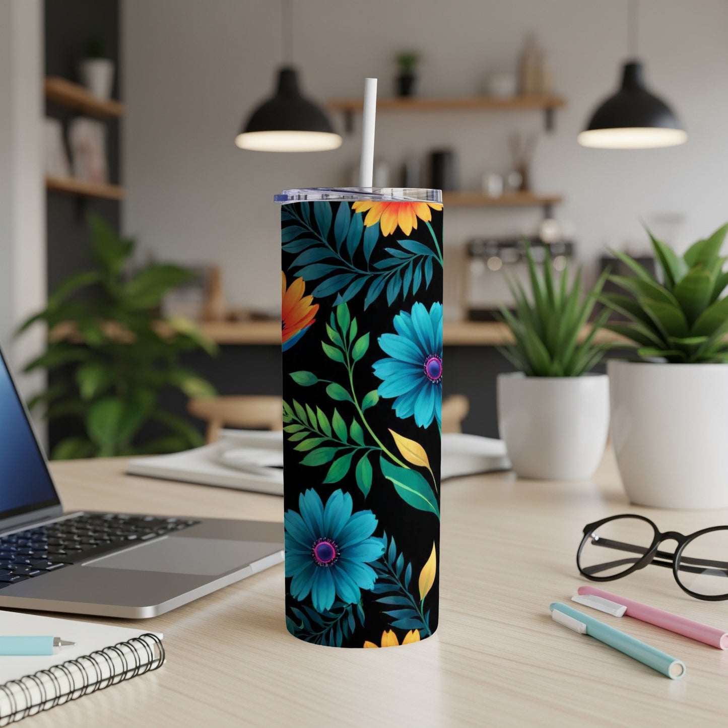 Black tumbler with vibrant blue, yellow, and orange floral pattern.