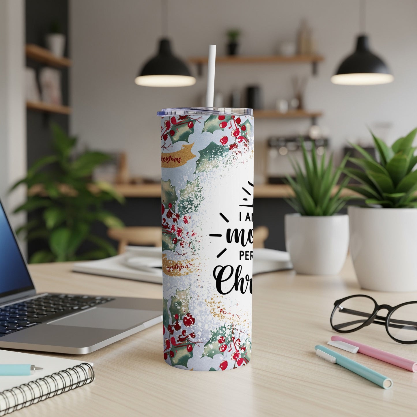 White tumbler with holly berries, snowflakes, and "I wish you a Merry Christmas" text.