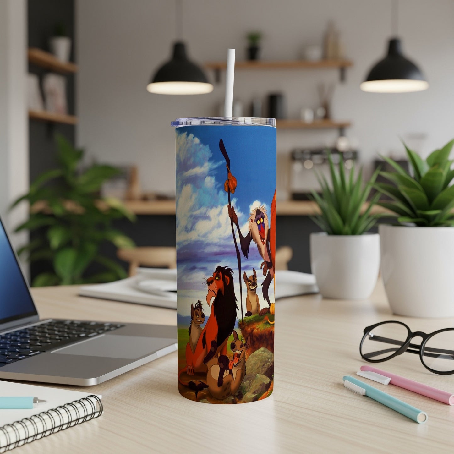 The Lion King characters Simba, Timon, and Pumbaa on a blue tumbler.