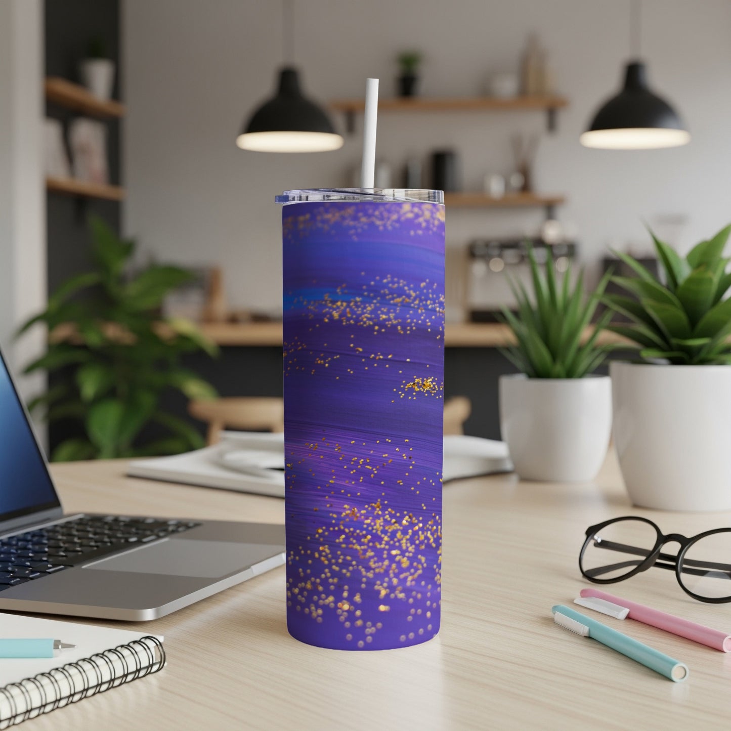 Purple glitter tumbler with white straw on a desk with laptop.