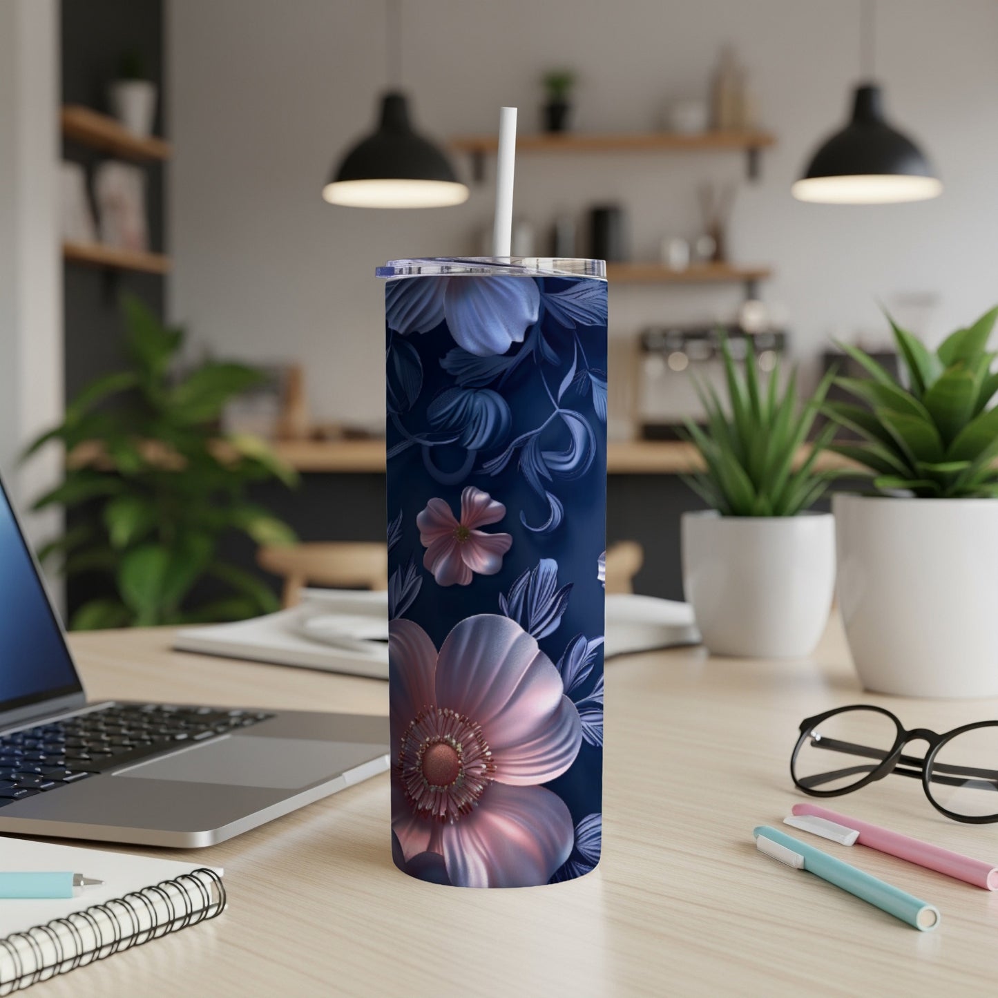 Dark blue tumbler with a floral pattern and a white straw.