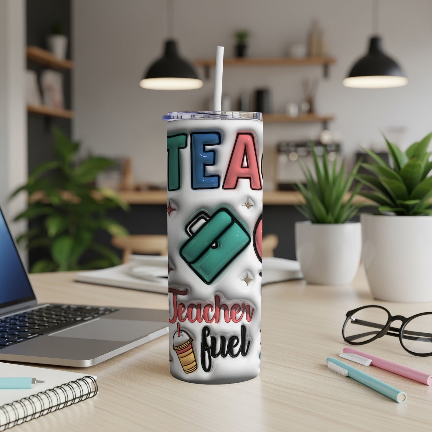 "Teacher fuel" tumbler with a laptop and supplies on a desk.