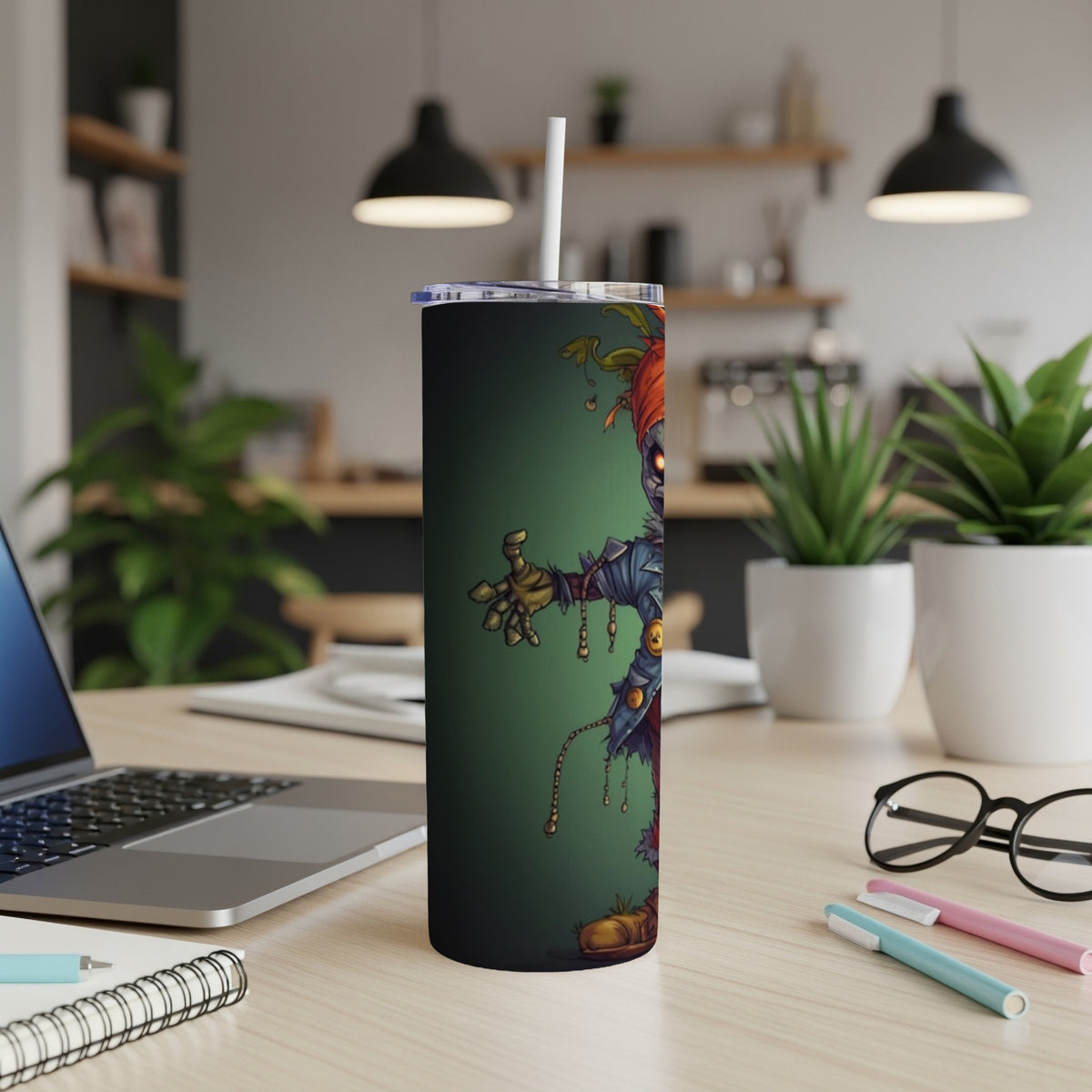 Tumbler with spooky clown illustration on green background, straw inserted.