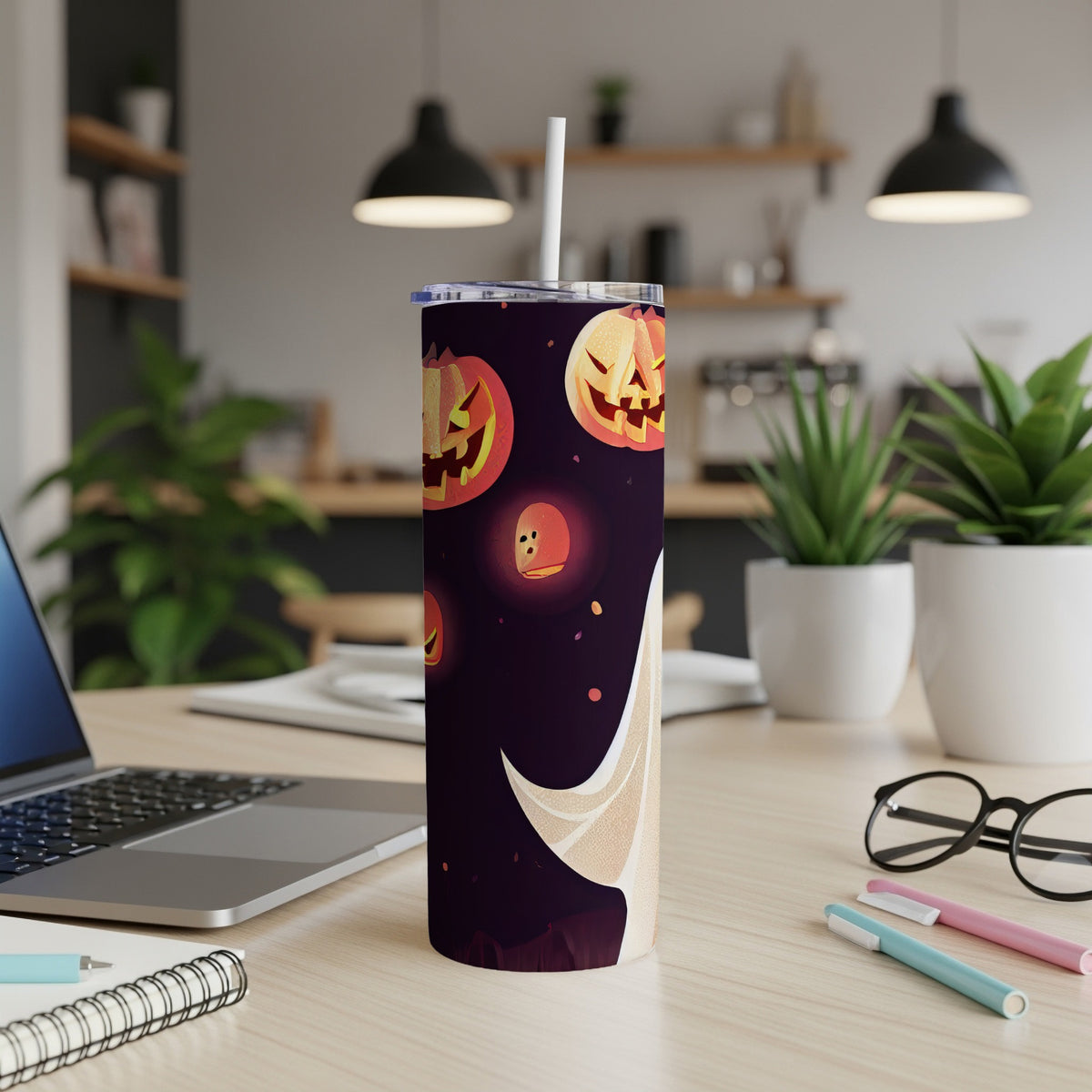 Tumbler with Halloween theme featuring pumpkins and ghosts on dark background.