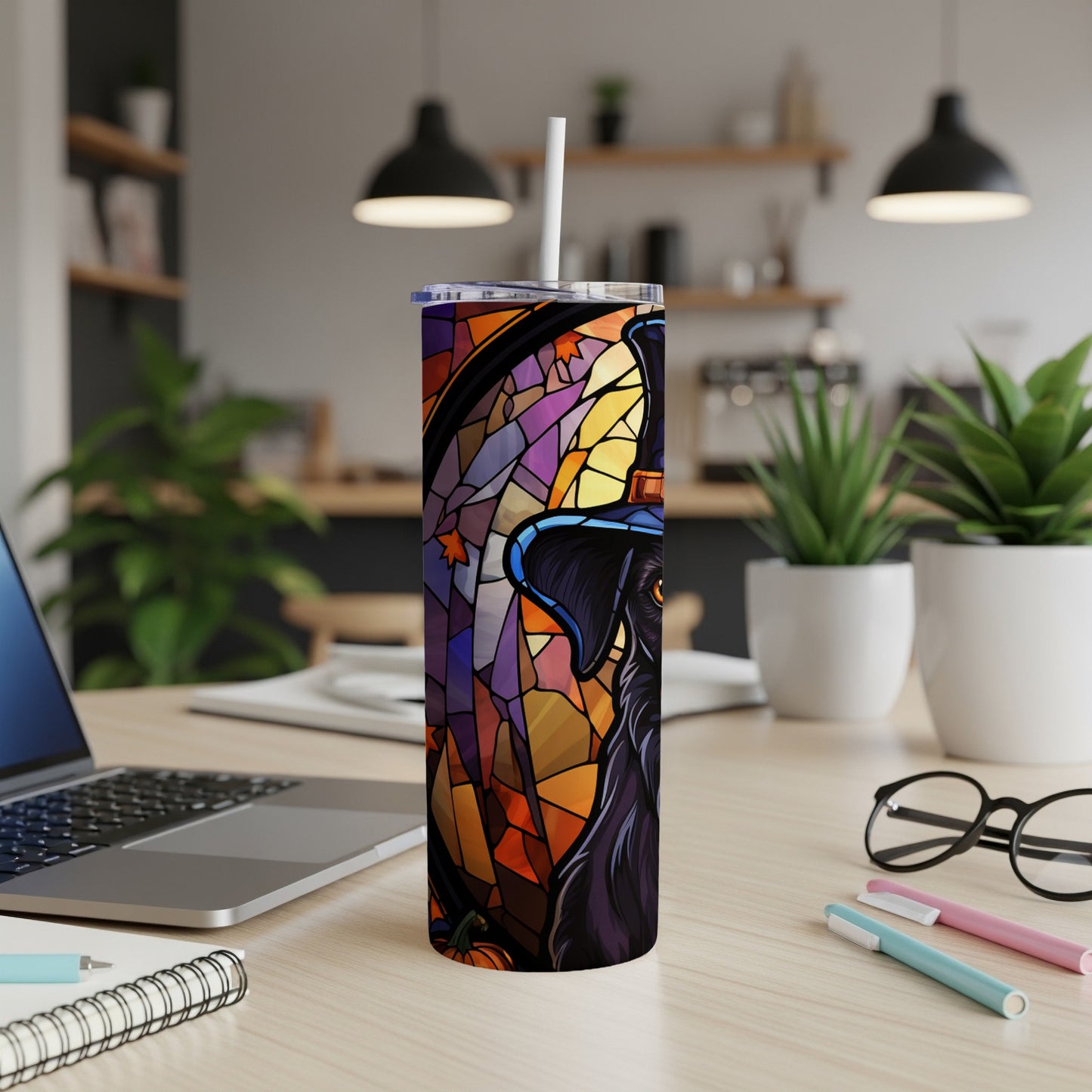 Black dog in witch hat, stained glass style, on a tumbler cup.