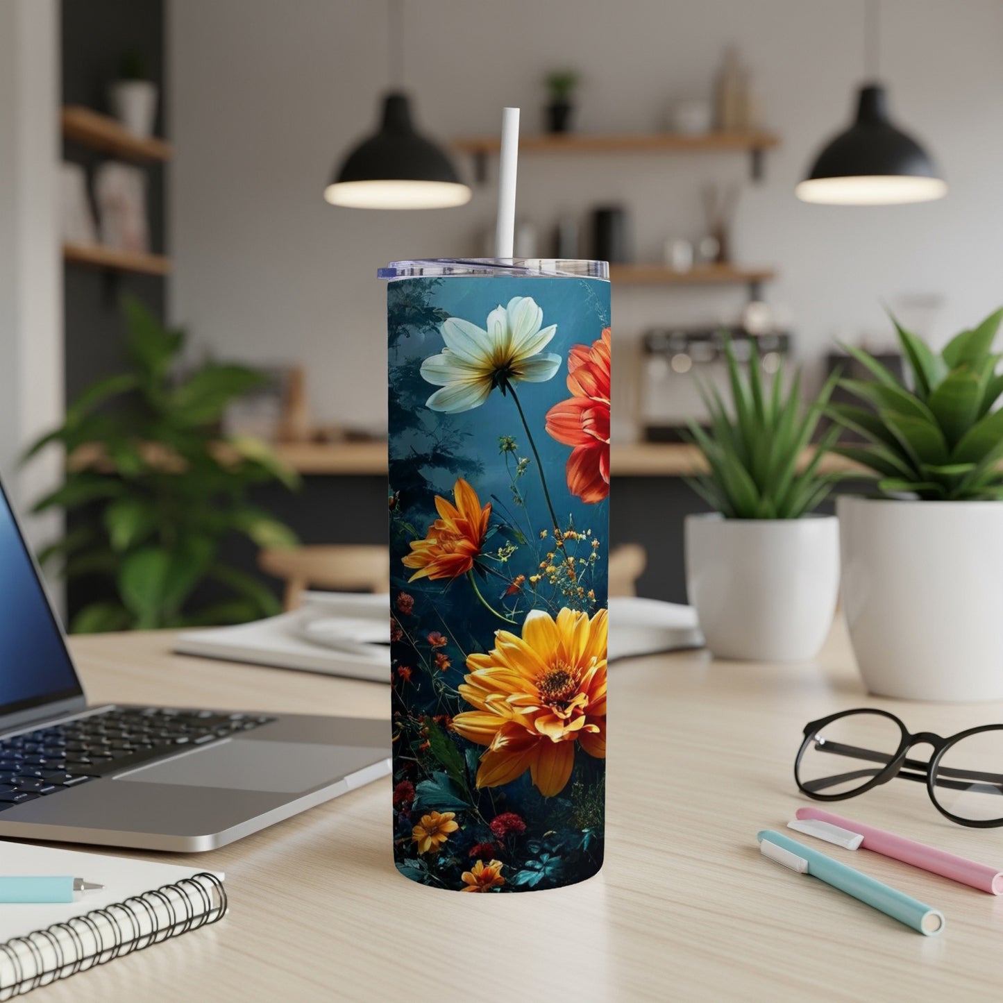 Floral pattern on a white skinny tumbler with a straw.