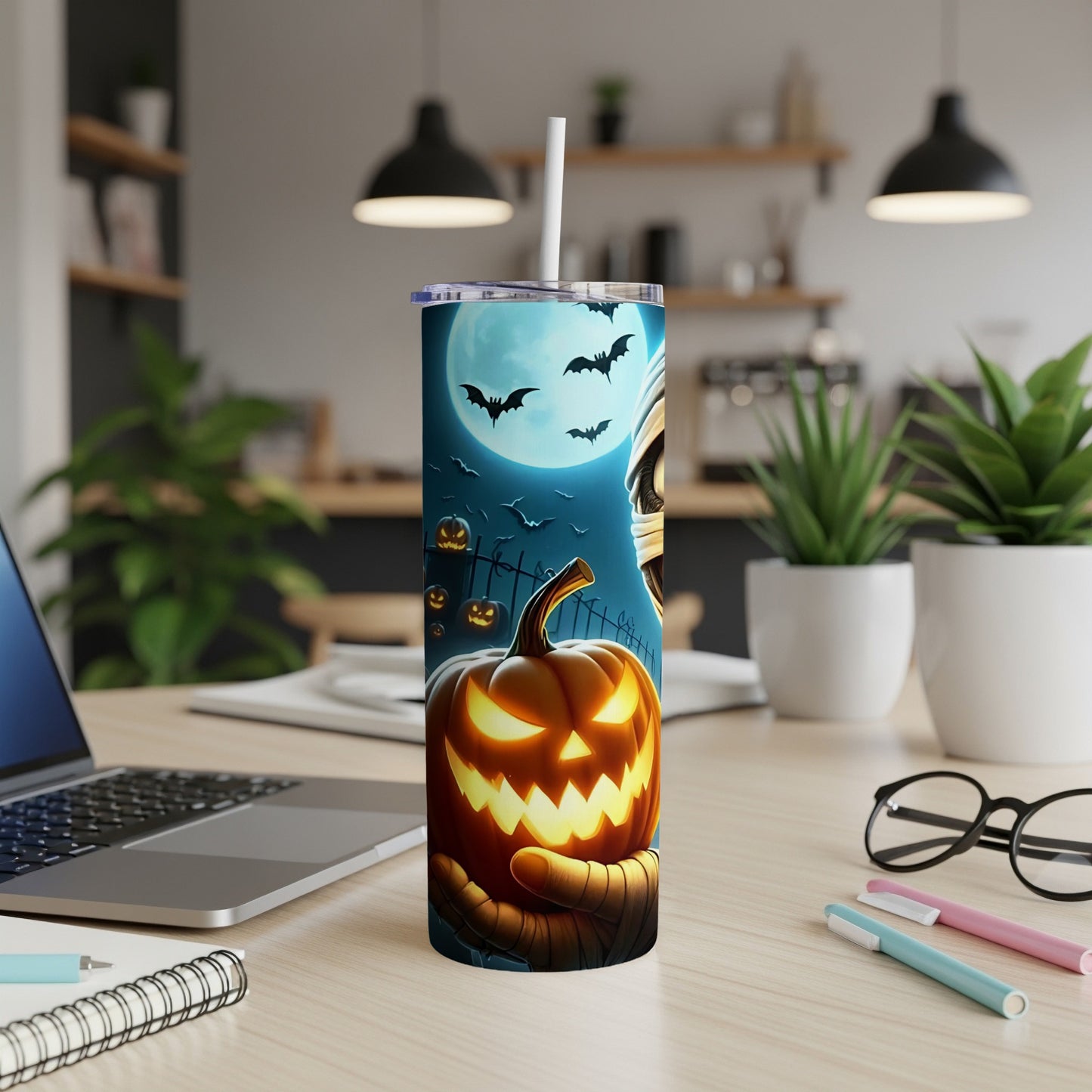 Halloween tumbler with mummy hand holding jack-o'-lantern, bats, and moon.