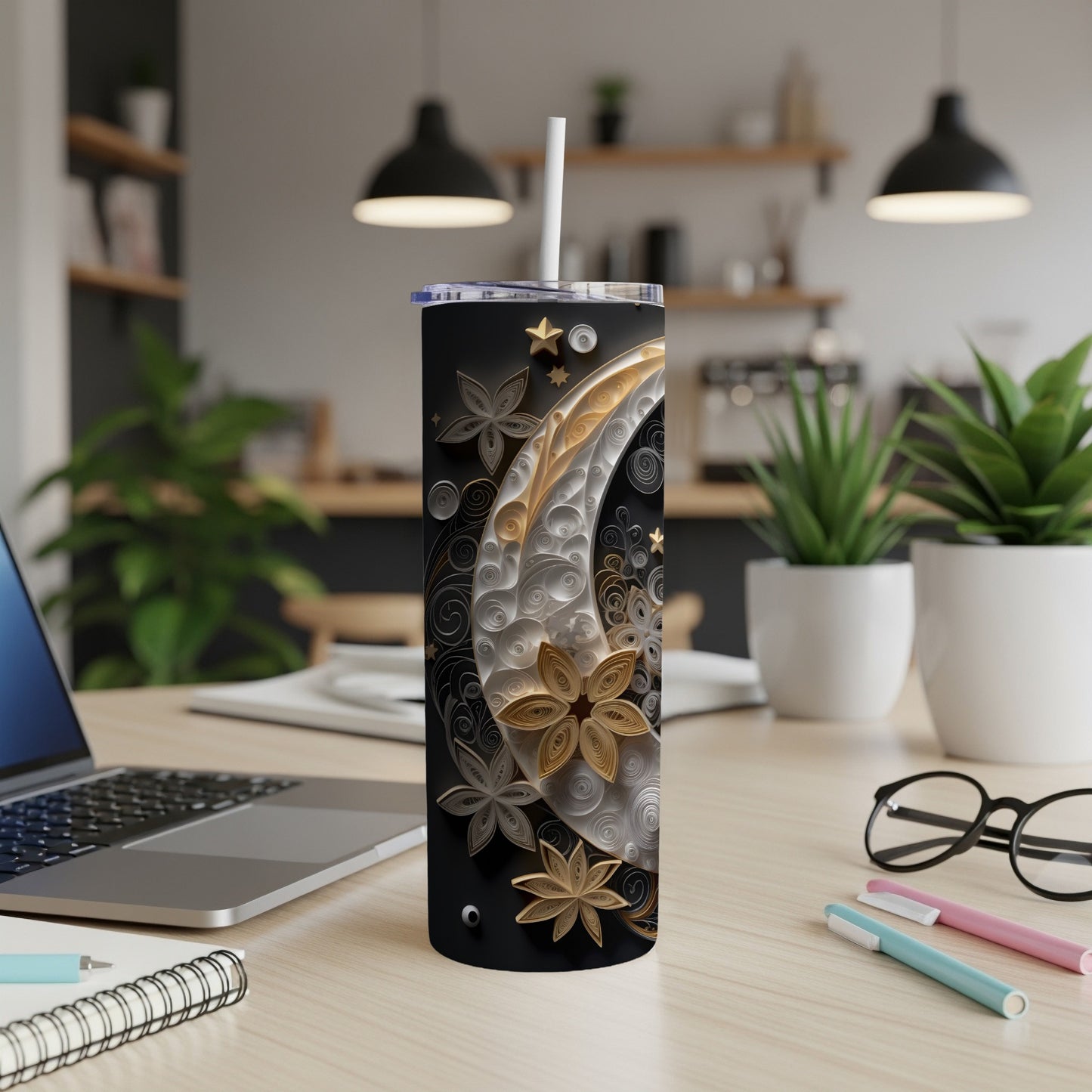 Black tumbler with ornate gold and white swirl design and straw.