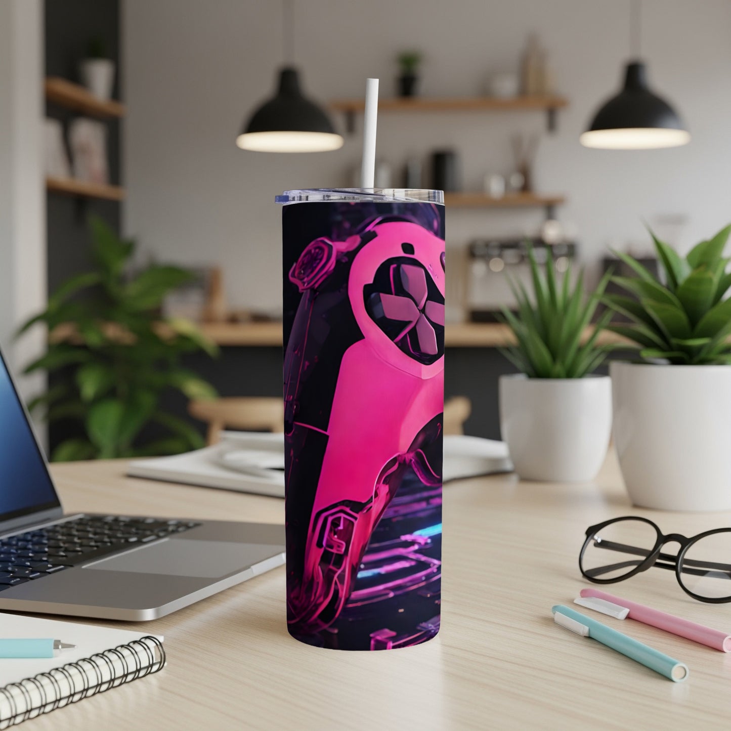 Pink gaming controller on a tumbler with a straw.