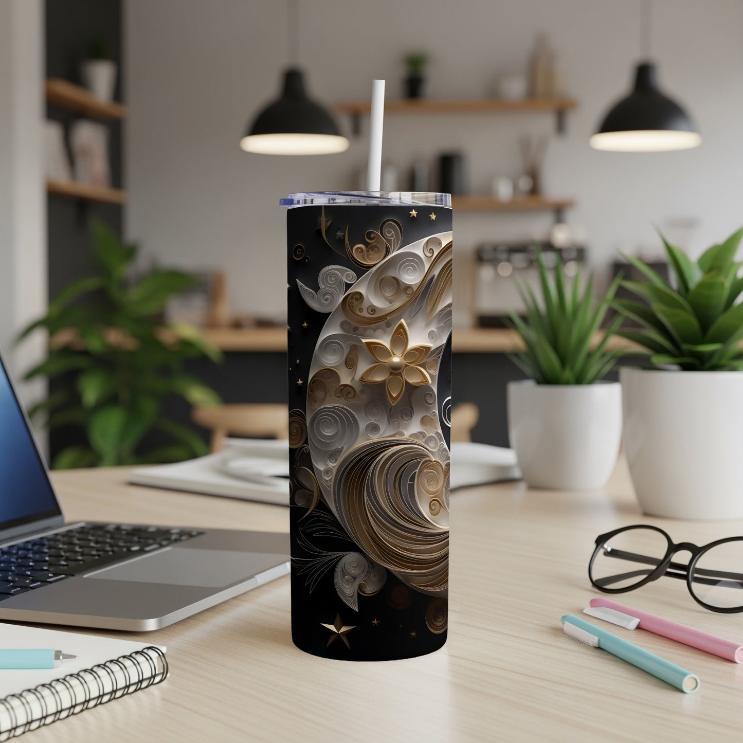 Black tumbler with gold celestial moon and stars design.