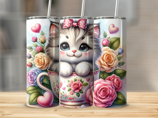 Cute kitten with pink bow in teacup surrounded by roses and hearts.