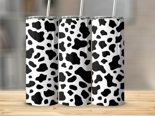 Three tumblers with a black and white cow print pattern.