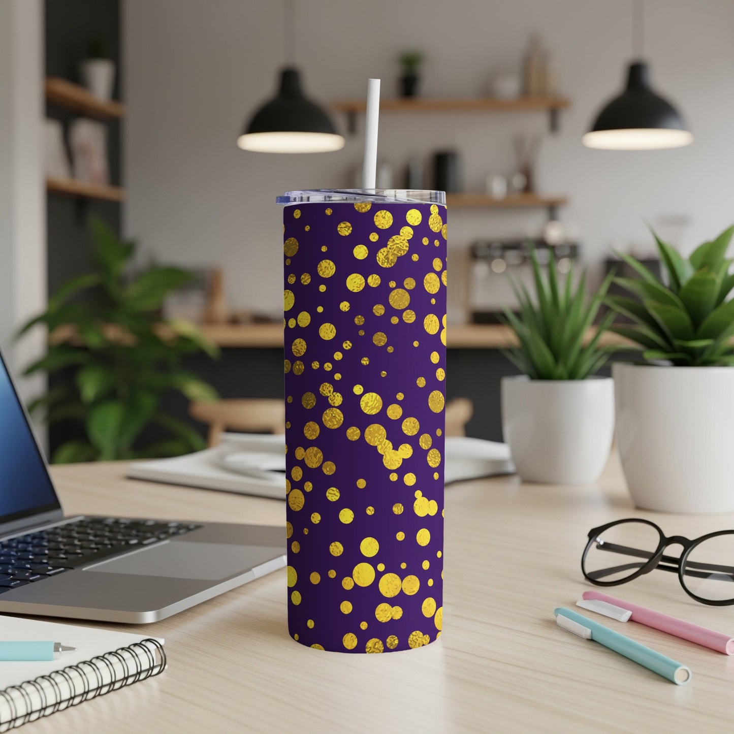 Purple tumbler with gold polka dots and a white straw.
