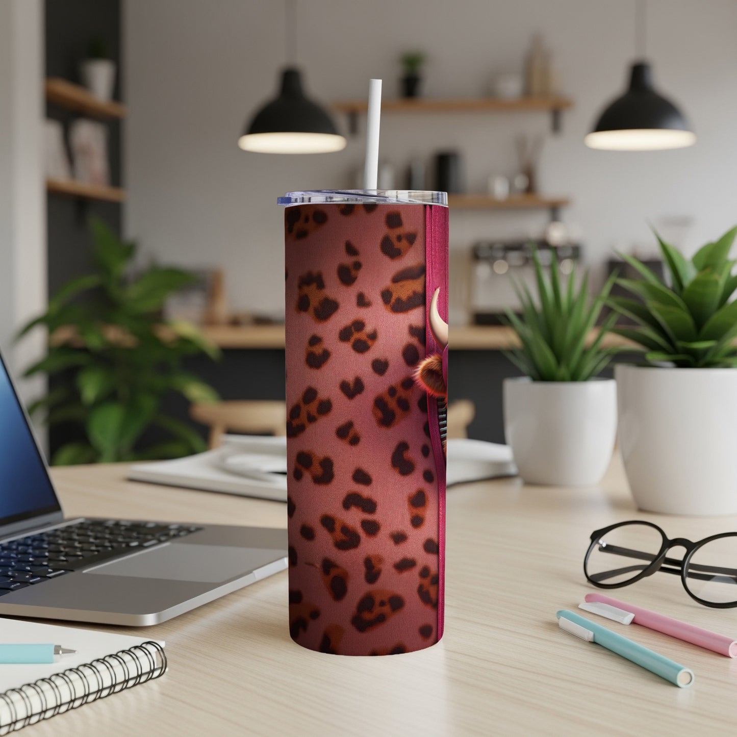 Leopard print tumbler with a bull's head design and straw.