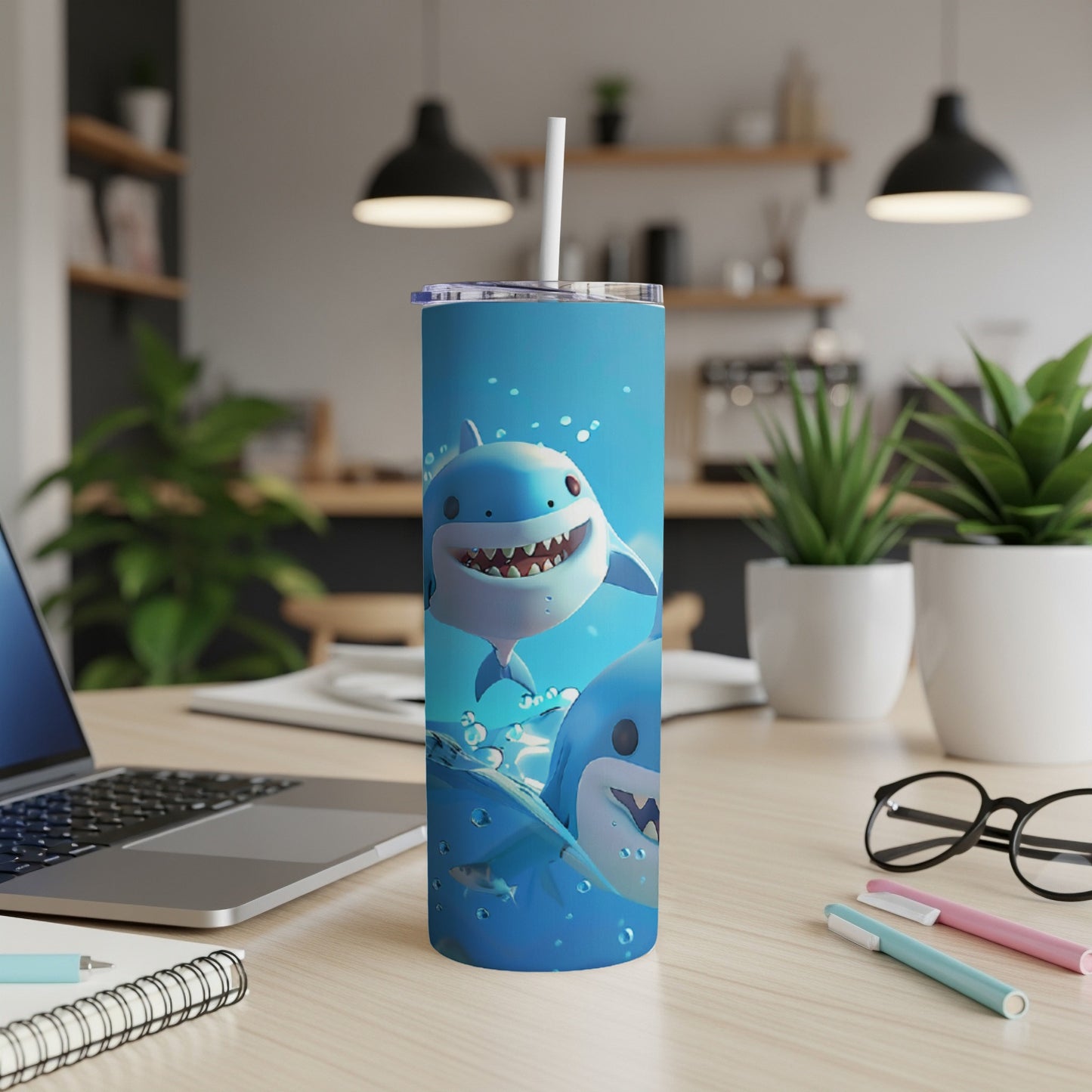 Cute cartoon sharks splashing in blue water on a tall tumbler.