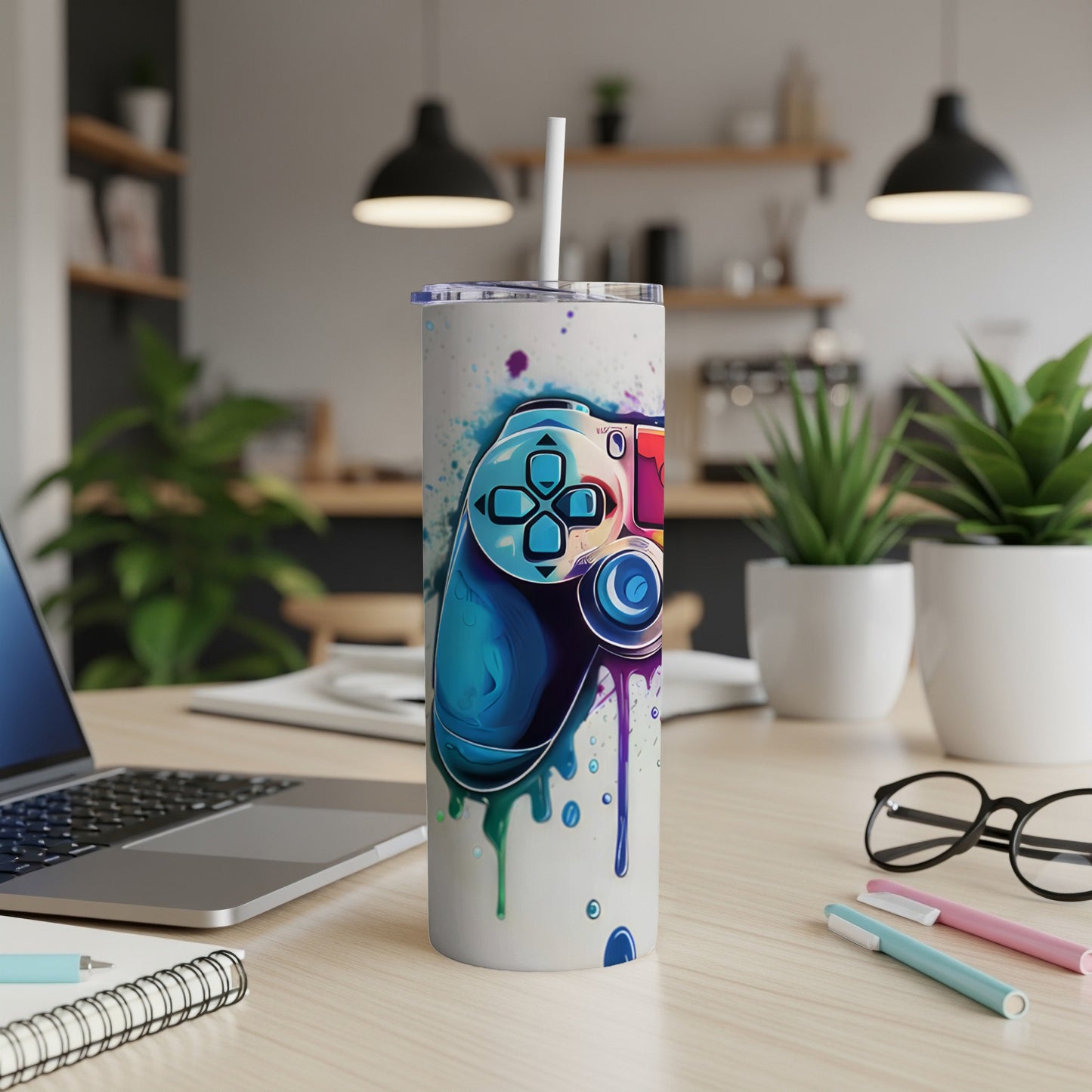 Graffiti-style game controller with colorful drips on a white tumbler.