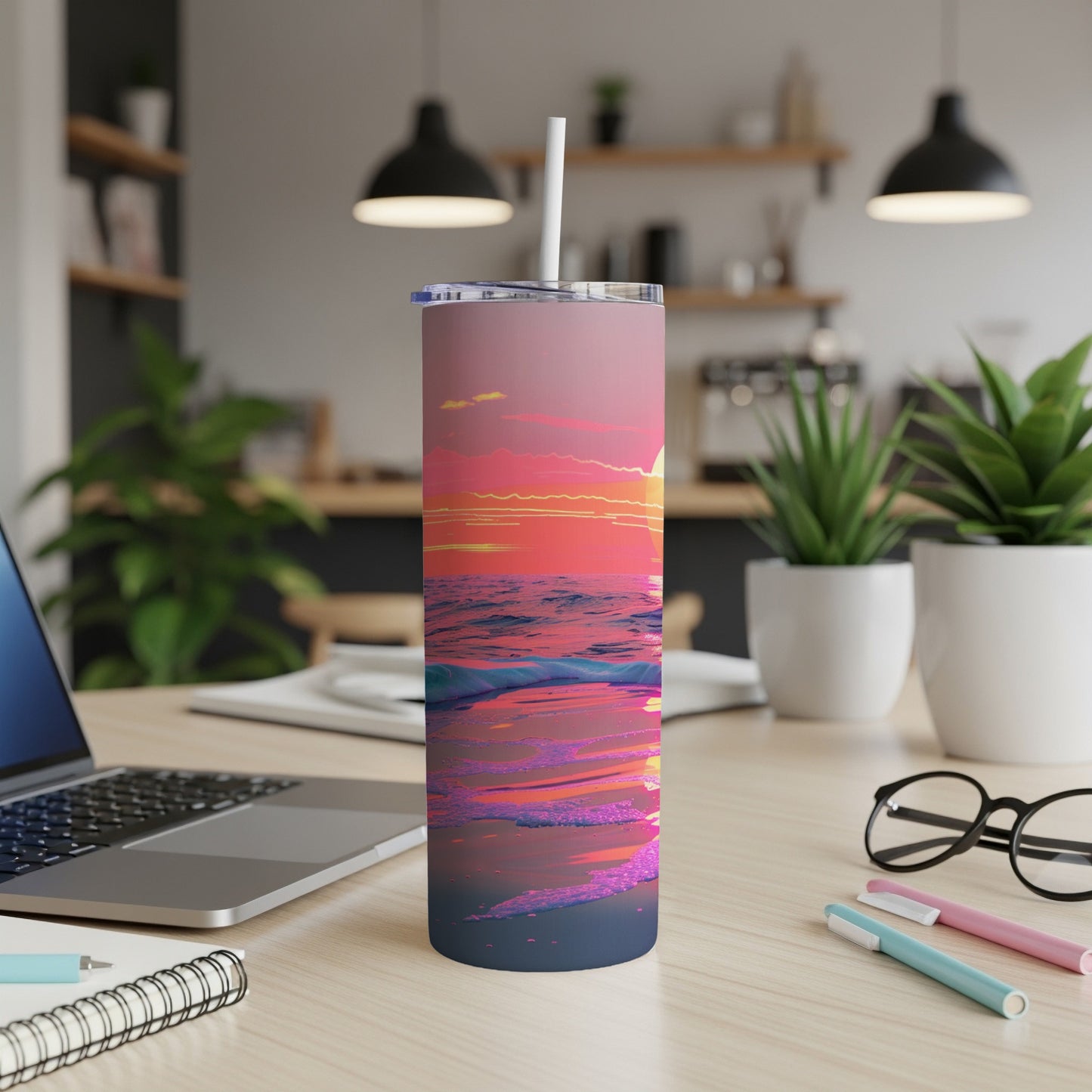Ocean waves and sunset on a pink and purple tumbler with a straw.