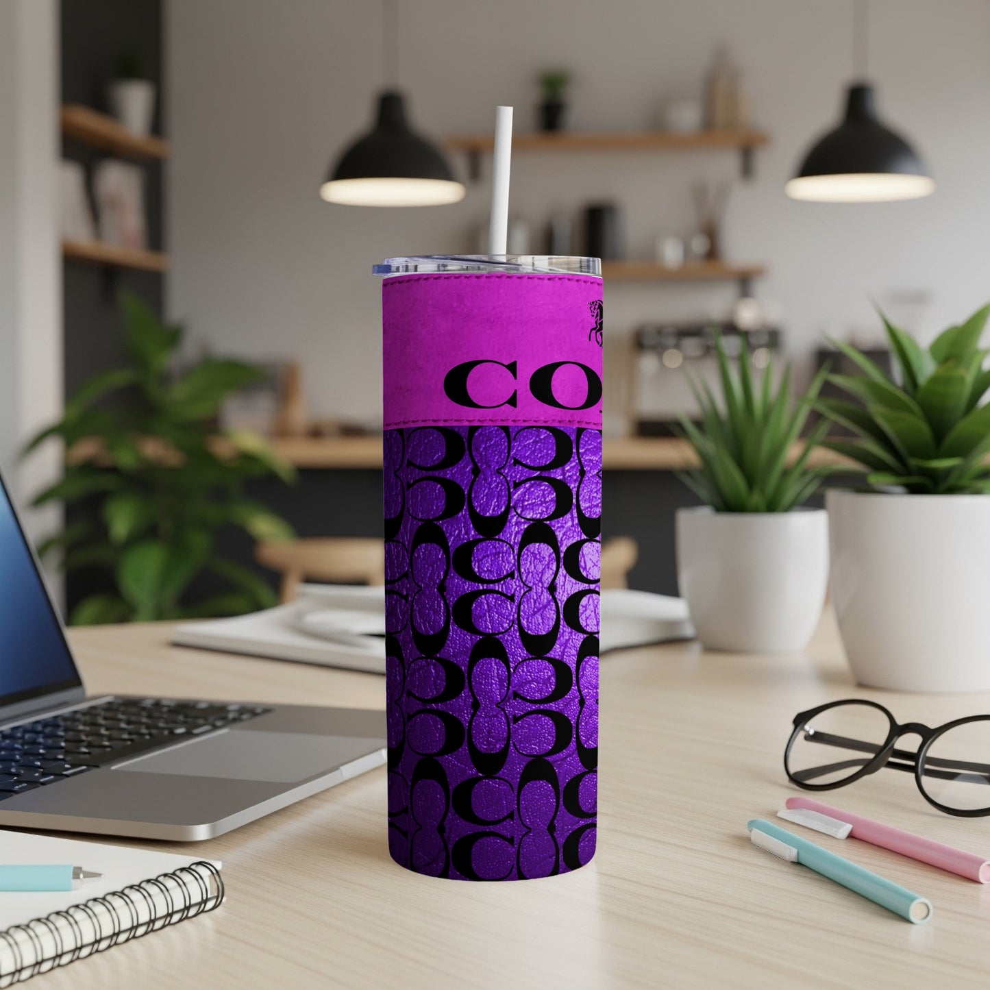 Purple tumbler with black Coach pattern, featuring "CO" text.